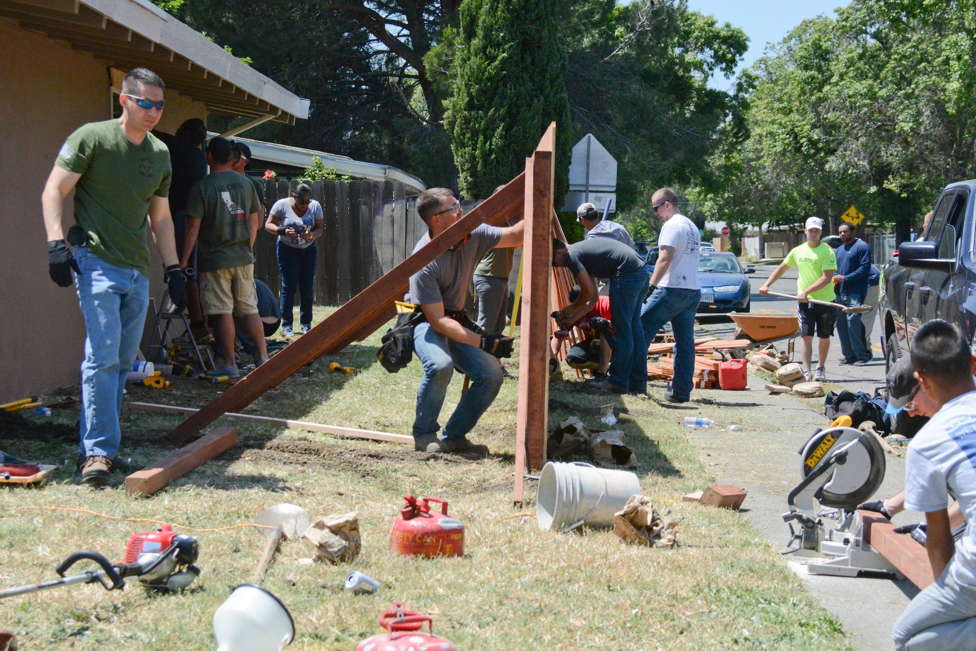 The 60th Civil Engineer Squadron and the Travis First Sergeants Council work together May 9 to repair the home of Teri Evans, mother of the late Airman 1st Class  Chris Evans. CES used their training to contribute to home repairs. (U.S. Air Force photo by Airman 1st Class Amber Carter)
