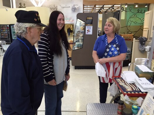 Volunteer popcorn pal Mary Lou Peterson (right) sells popcorn to Glenn Wilson, retired from the Air Force as a technical sergeant and B-52 crew chief after 21 years of service, and his friend Sandra Wells. Proceeds from the sale of popcorn in the Wright-Patterson Medical Center help to fund the base's Fisher Houses. (Skywrighter photos by Amy Rollins)