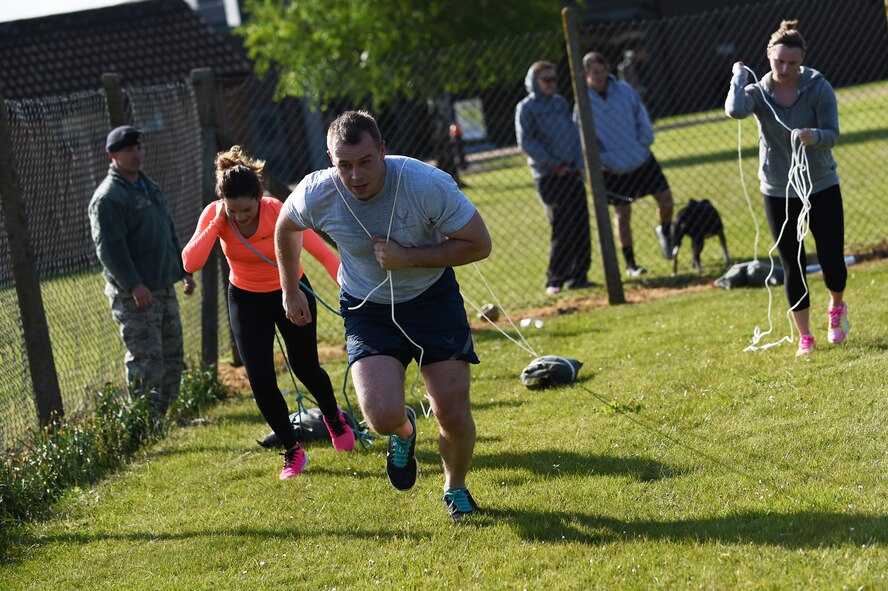 Staff Sgt. Wyoming Jeffries, 423rd Medical Squadron laboratory technician, leads his team during the sandbag drag portion of the National Police Week Warrior Challenge at RAF Alconbury, England, May 15, 2015. The team-based, timed competition consisted of a litter carry, 100-meter tire flip challenge, ladder run, fireman’s carry, sandbag drag and run, half-mile “last-man-up” run and weighted lunges, with quarter-mile runs in between each event. (U.S. Air Force photo by Staff Sgt. Jarad A. Denton/Released)