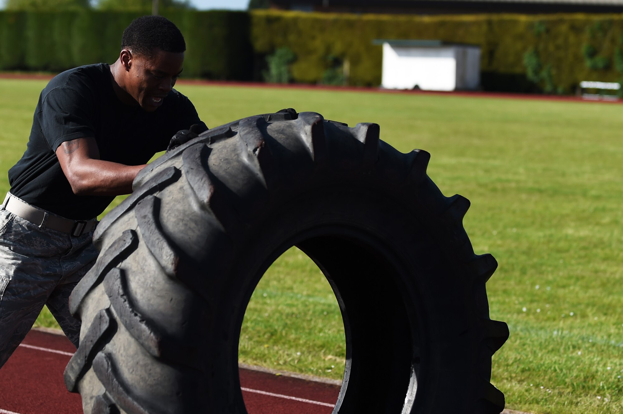 Staff Sgt. Tim Woodard, 423rd Security Forces Squadron combat arms instructor, flips a tire during the National Police Week Warrior Challenge at RAF Alconbury, England, May 15, 2015. Woodard, along with his team, participated in the challenge to test their physical fitness and show support for all law enforcement officers who have been killed in the line of duty. (U.S. Air Force photo by Staff Sgt. Jarad A. Denton/Released)