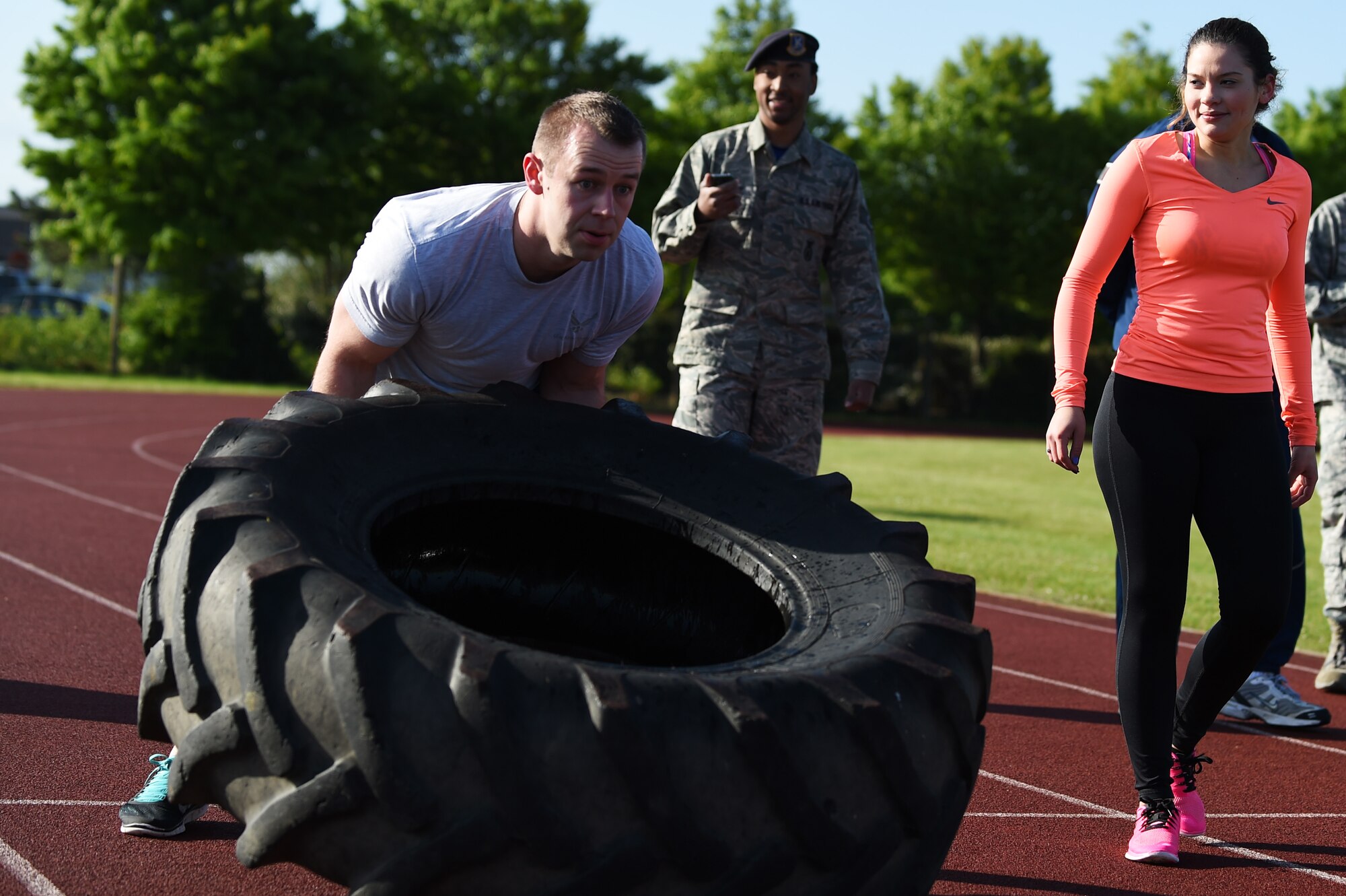 Staff Sgt. Wyoming Jeffries, 423rd Medical Squadron laboratory technician, flips a tire during the National Police Week Warrior Challenge at RAF Alconbury, England, May 15, 2015. Jeffries and his team finished the entire challenge in 54:05. (U.S. Air Force photo by Staff Sgt. Jarad A. Denton/Released)