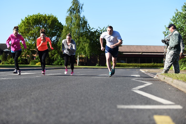 The first team to tackle the Warrior Challenge takes off from the starting line at RAF Alconbury, England, May 15, 2015. The challenge was held to show support of National Police Week. (U.S. Air Force photo by Staff Sgt. Jarad A. Denton/Released)