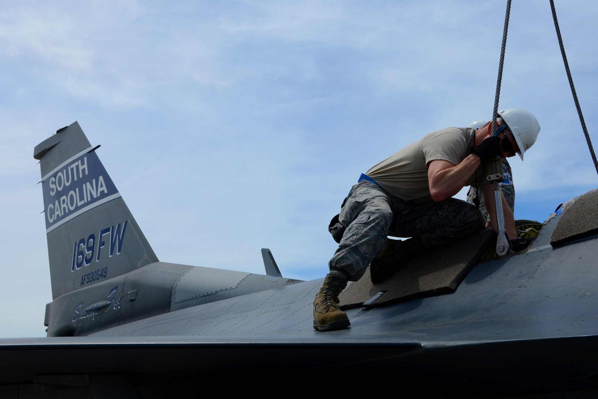 U.S. Air Force Tech. Sgt. Donald Murphy, a crew chief with the 169th Maintenance Squadron, attaches an aircraft hoisting sling onto an F-16 Fighting Falcon during a Major Aircraft Recovery Exercise (MARE) May 6, 2015 at McEntire Joint National Guard Base, S.C. The MARE exercise was a base-wide training simulation to determine how McEntire would respond to an aircraft crash. (U.S. National Guard photo by Amn Megan Floyd/Released)