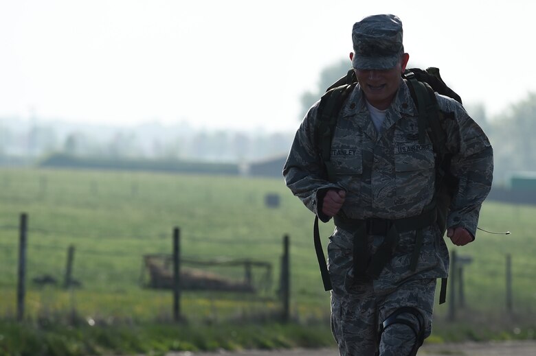 Chaplain (Maj.) Jack Stanley, 422nd Air Base Group chaplain, runs along the perimeter road at RAF Croughton, England, May 11, 2015, during a ruck march in honor of National Police Week. The event was held to honor law enforcement officers who have given their lives in the line of duty. (U.S. Air Force photo by Staff Sgt. Jarad A. Denton/Released)