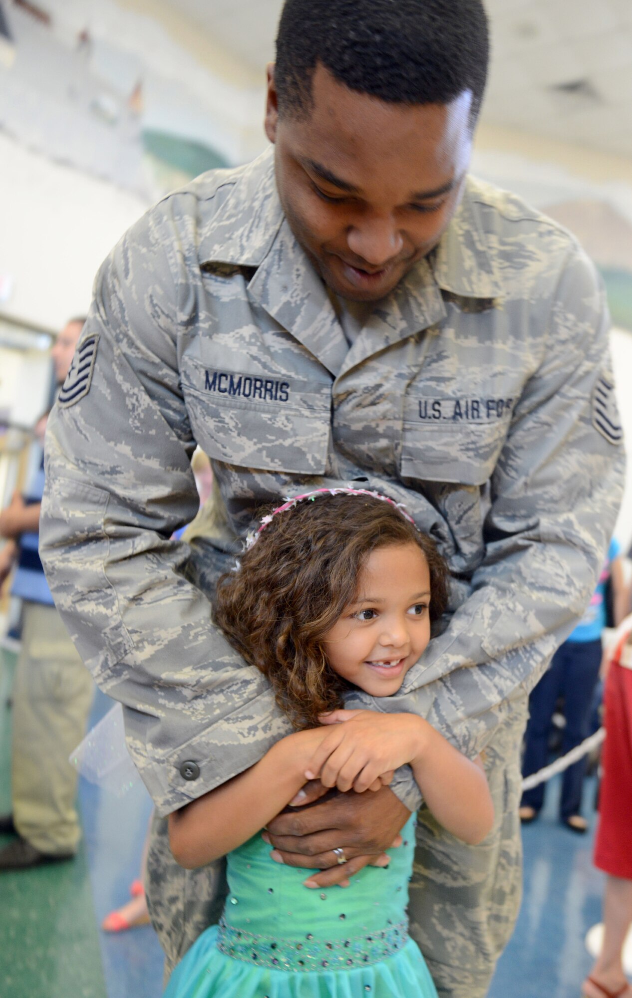 Tech. Sgt. Branden McMorris and his daughter, Kambrie, get ready to dance. (U.S. Air Force photo by Tommie Horton)
