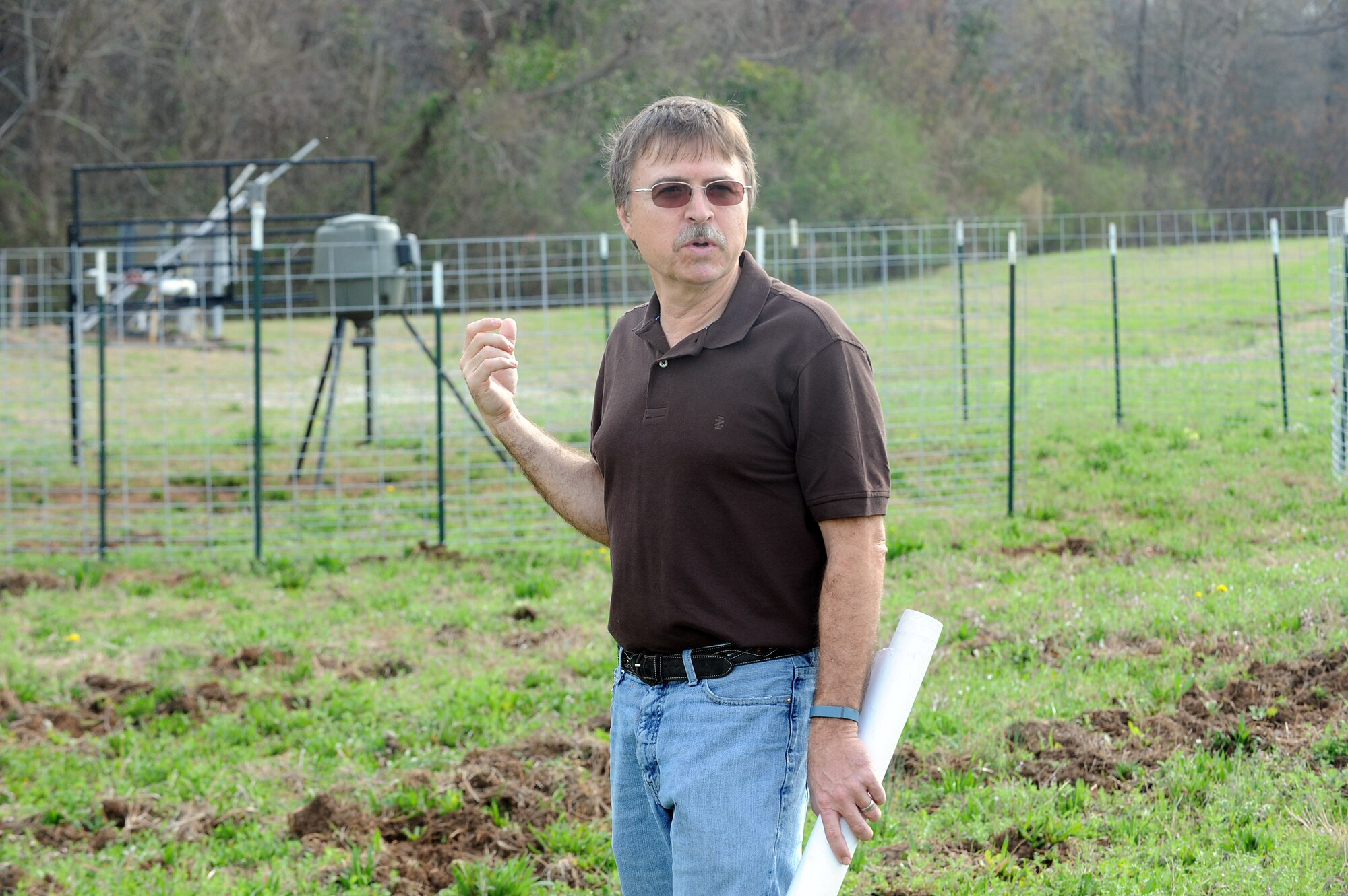 Bob Sargent, Robins’ natural resources manager and wildlife biologist, surveys an area damaged by wild hogs. (U.S. Air Force photo by Tommie Horton)