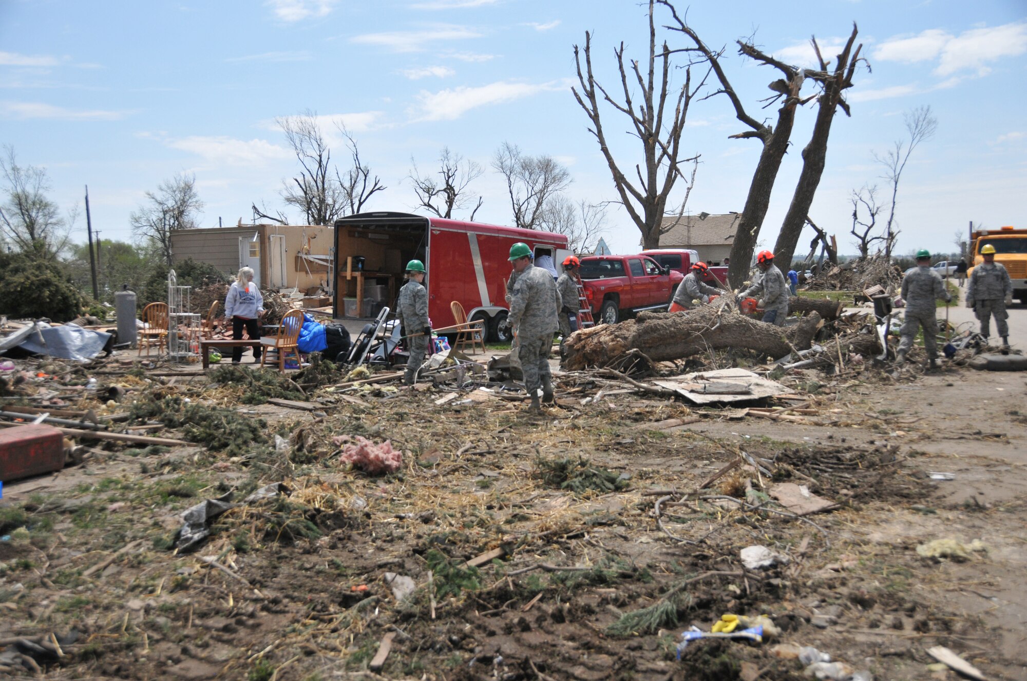 DELMONT, S.D. - Members of the 114th Civil Engineer Squadron of the South Dakota Air National Guard work alongside Delmont residents to assist with tornado recovery efforts after the city was hit by an F2 tornado on May 11, 2015.  Twenty-five members of the unit, as well as heavy equipment,  were activated for a period of up to five days to assist with the removal of large debris in the area.(National Guard photo by Senior Master Sgt. Nancy Ausland/released)
