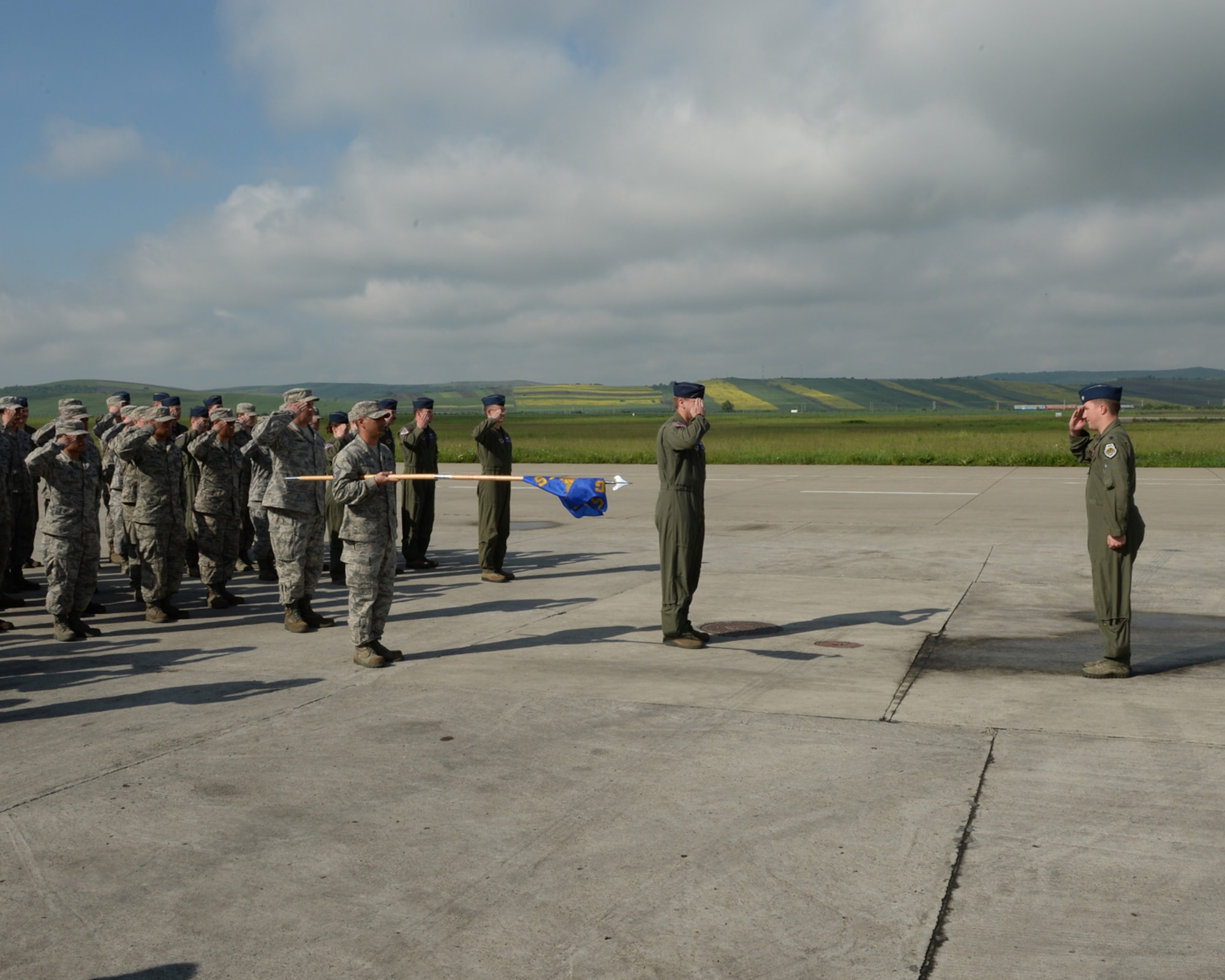 U.S. Air Force Lt. Col. Ryan Hayde, 354th Expeditionary Fighter Squadron commander, salutes the 354th EFS for the first time during a change-of-command ceremony May 15, 2015, on the flightline at Campia Turzii, Romania. Hayde is a senior pilot with more than 1,800 flying hours including 323 hours in combat. (U.S. Air Force photo by Senior Airman Dylan Nuckolls/Released)