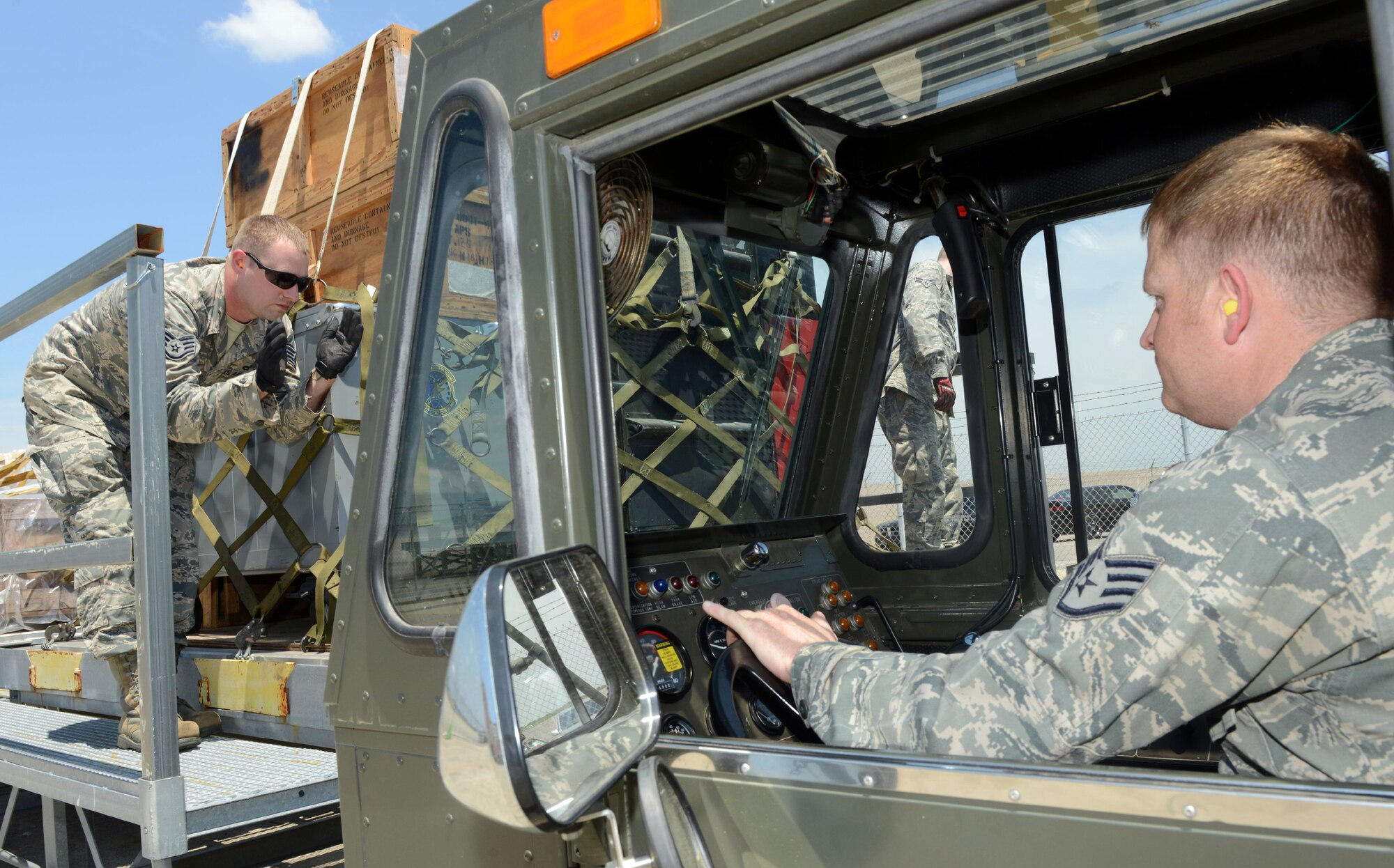 Staff Sgt. Clinghton Smith, 78th Logistics Readiness Squadron air transportation specialist, guides Staff Sgt. Aaron Belew, 78th LRS craftsman, as he positions a K-Loader to be loaded with cargo. (U.S. Air Force photo by Tommie Horton)