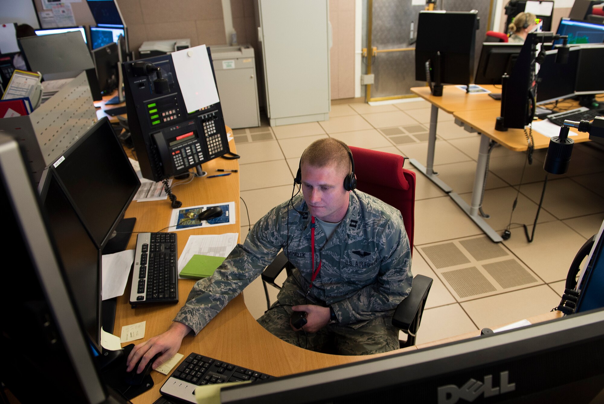 U.S. Air Force Capt. David Mihalek, 871st Air Expeditionary Squadron control and reporting center, monitor Icelandic airspace in the CRC during Icelandic Air Surveillance and Policing May 1, 2015. Eleven U.S. and one Estonian controller are augmenting the permanent Icelandic Coast Guard presence in the CRC for the duration of the air surveillance mission. (U.S. Air Force photo by Staff Sgt. Chad Warren/Released)