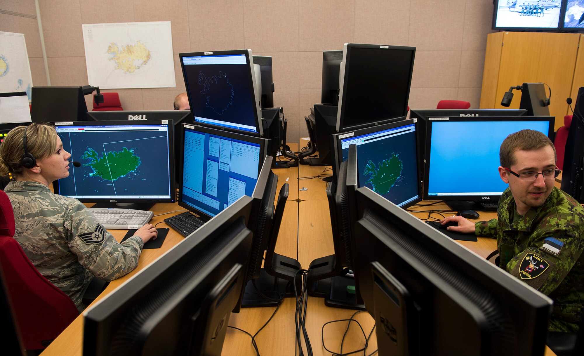 U.S. Air Force Staff Sgt. Hailey Sundberg and Estonian air force Lt. Tõnis Pärn, 871st Air Expeditionary Squadron control and reporting center, monitor Icelandic airspace in the CRC during Icelandic Air Surveillance and Policing May 1, 2015. The CRC is the nerve center of communications and operations for the IAS mission. (U.S. Air Force photo by Staff Sgt. Chad Warren/Released)