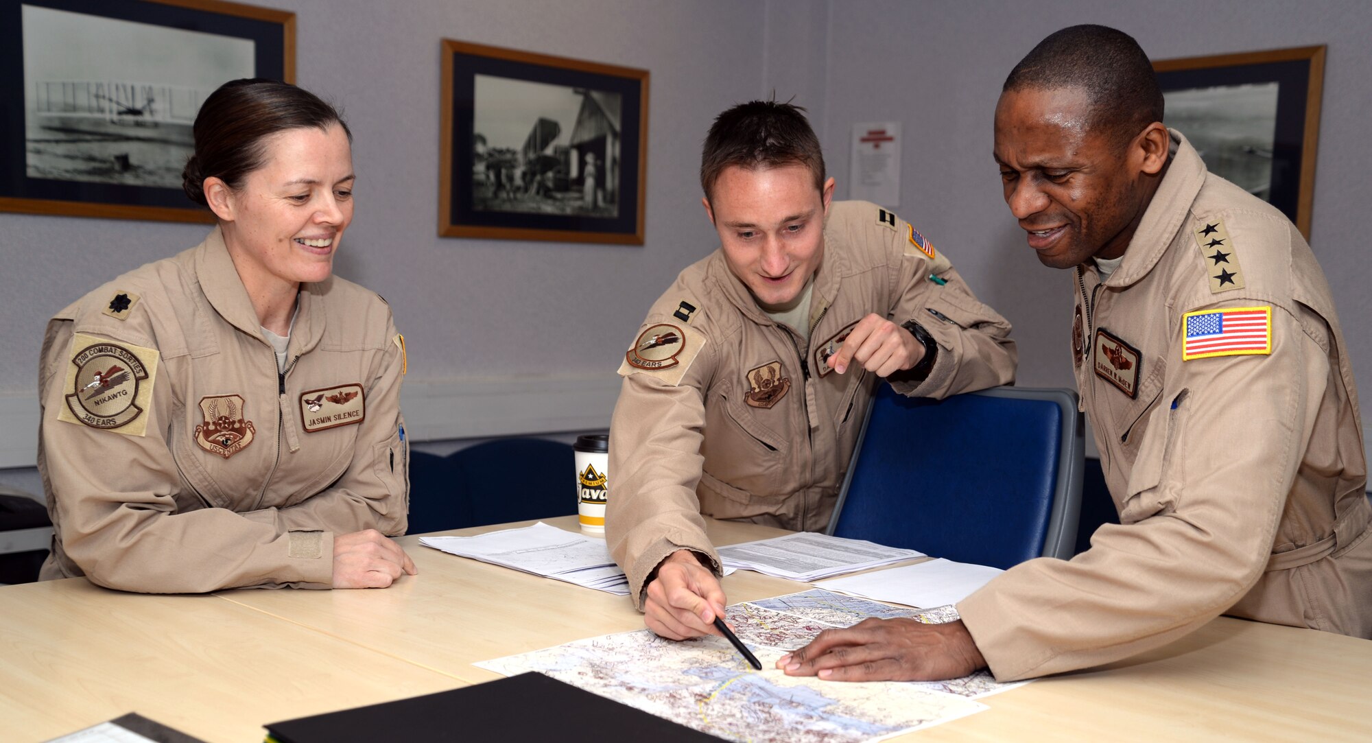U.S. Air Force Gen. Darren W. McDew, right, Air Mobility Command commander, goes over a flight plan with aircrew members April 22, 2015, on RAF Mildenhall, England. McDew visited RAF Mildenhall for a day, meeting Airmen from different squadrons and learning first-hand how Team Mildenhall refuels the fight. (U.S. Air Force Photo by Senior Airman Christine Halan/Released)