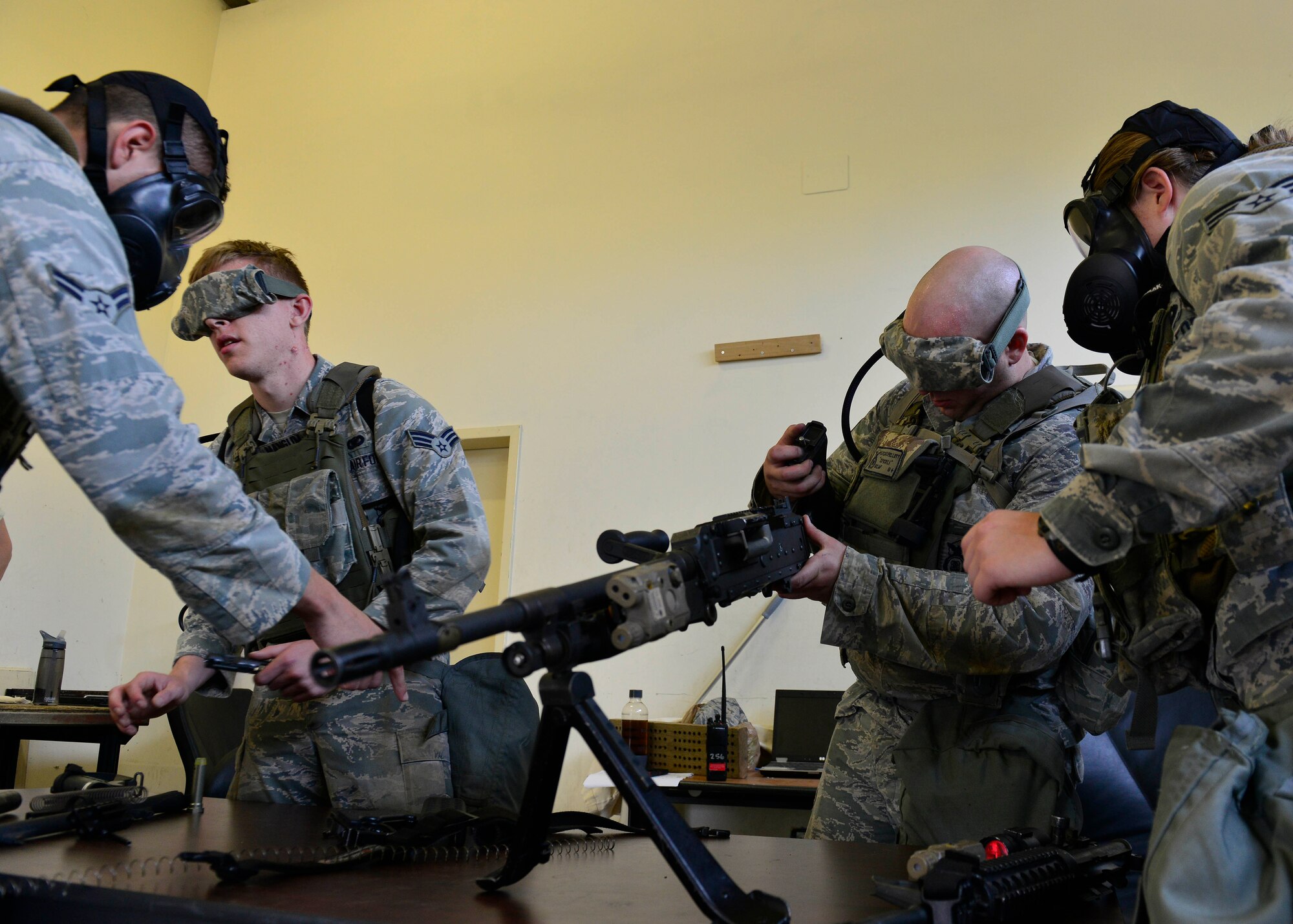 U.S. Air Force defenders assemble weapons blindfolded during the Security Forces Squadron Fire Team Challenge for Police Week, May 13, 2015, at Aviano Air Base, Italy.  The weapons assembly was one of 12 stations set up to test mental and physical strength.   During the week, ceremonies, memorials and other events took place to honor the men and women who have served in the line of duty. (U.S. Air Force photo by Airman 1st Class Cary Smith/Released)