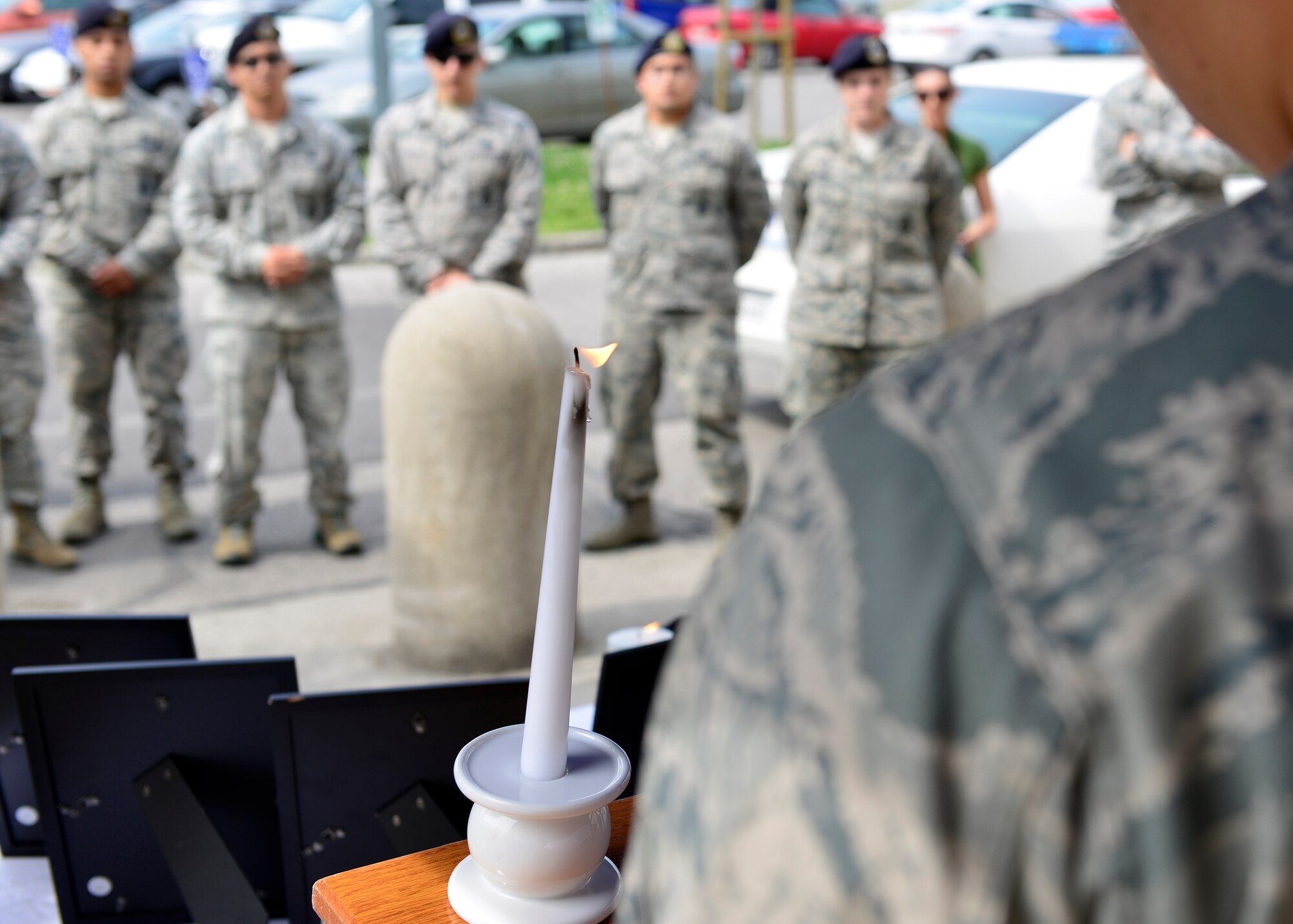 U.S. Air Force Airman 1st Class Woo Lee reads fallen defenders and law enforcement names at the start of a candle light vigil during Police Week, May 12, 2015, at Aviano Air Base, Italy.  Names were read during a 24-hour period to honor those listed.  (U.S. Air Force photo by Airman 1st Class Cary Smith/Released)