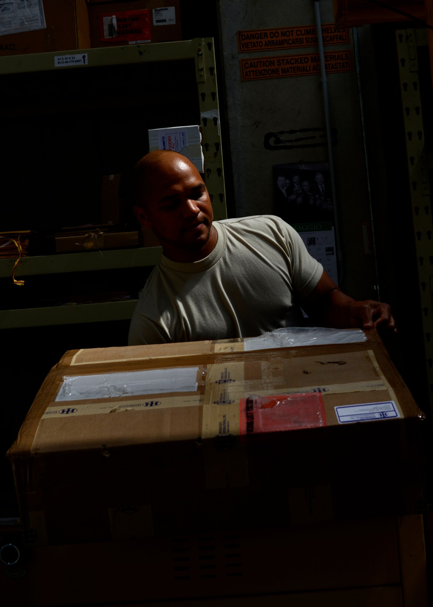 U.S. Air Force Airman 1st Class Anthony Abraham, 31st Logistics Readiness Squadron traffic management office journeyman, prepares a package for shipment, May 12, 2015, at Aviano Air Base, Italy. Cargo Airmen are responsible for transporting items daily such as aircraft engines and other supplies on a daily basis. (U.S. Air Force Senior Airman Areca T. Wilson/Released)
