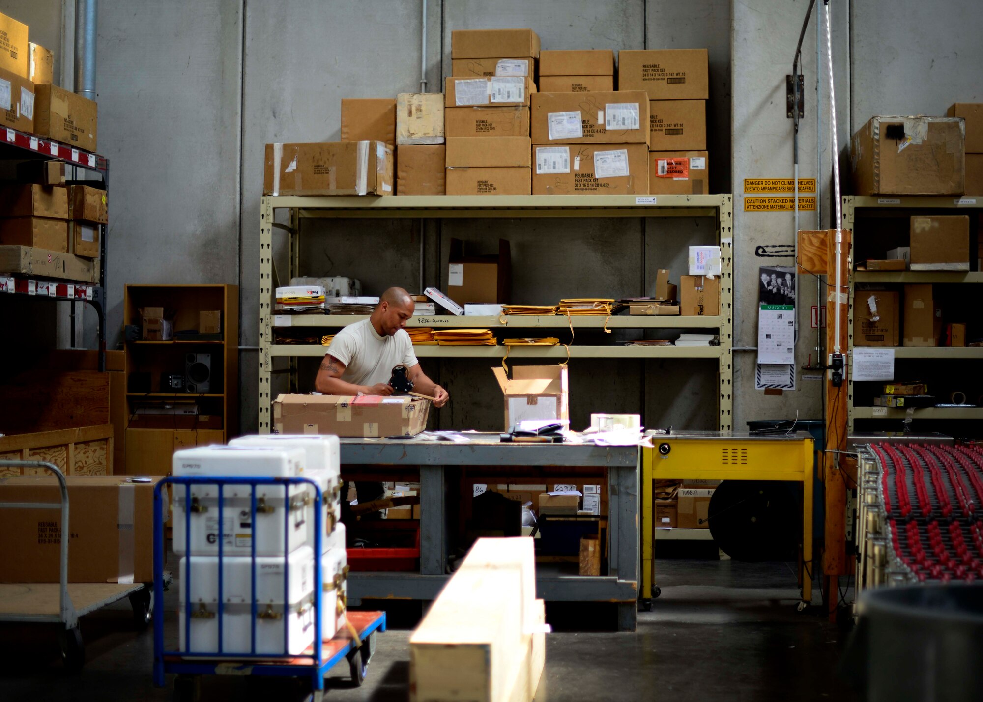 U.S. Air Force Airman 1st Class Anthony Abraham, 31st Logistics Readiness Squadron traffic management office journeyman, prepares a package for shipment, May 12, 2015, at Aviano Air Base, Italy. Cargo Airmen are responsible for transporting items such as aircraft engines and other supplies on a daily basis. (U.S. Air Force Senior Airman Areca T. Wilson/Released)