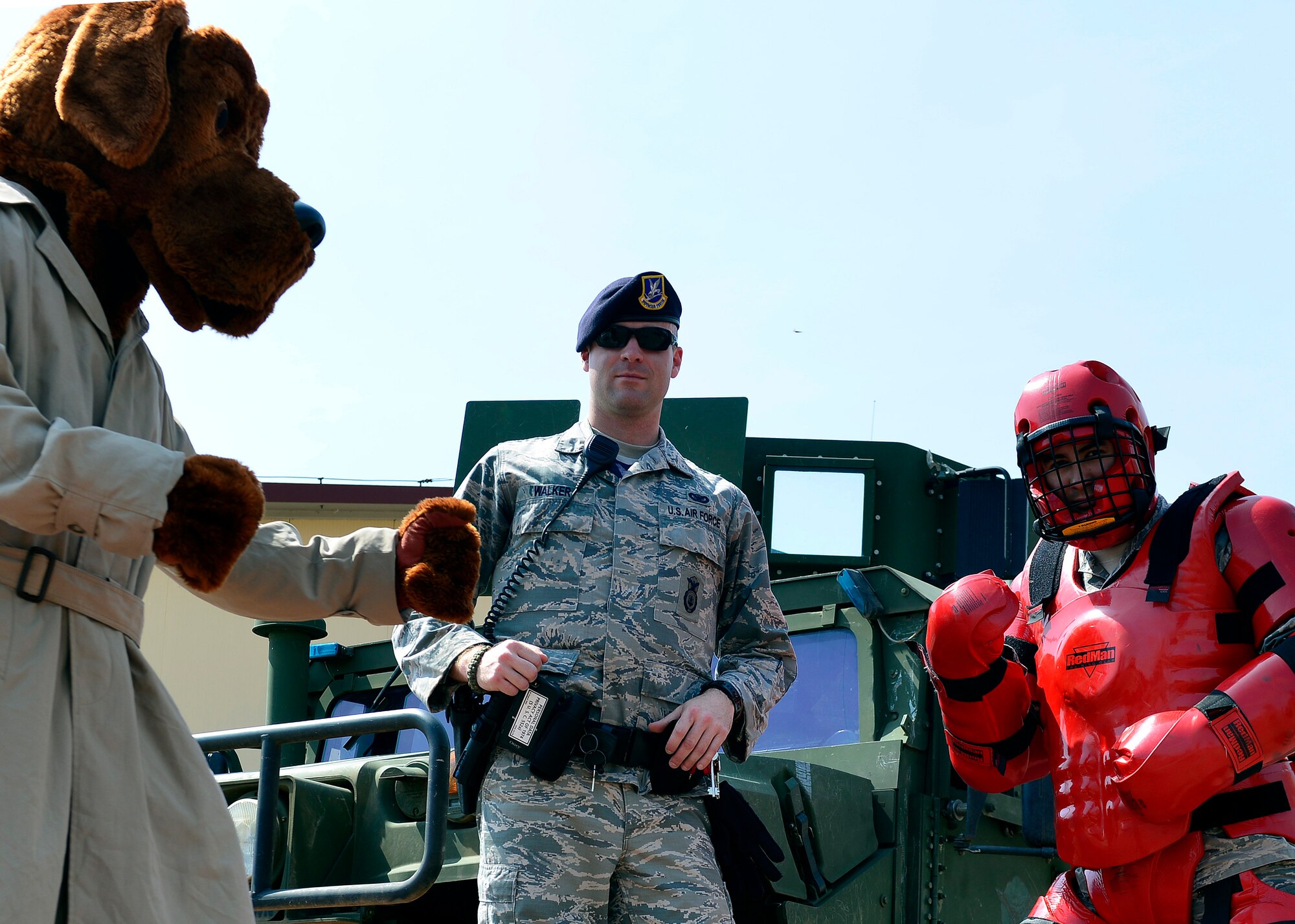 U.S. Air Force Senior Airmen Revik Walker poses for photo with McGruff and a “redman” at a police demonstration during Police Week, May 12, 2015, at Aviano Air Base, Italy.  During the week, ceremonies, memorials and other events took place to honor the men and women who have served in the line of duty. (U.S. Air Force photo by Airman 1st Class Cary Smith/Released)