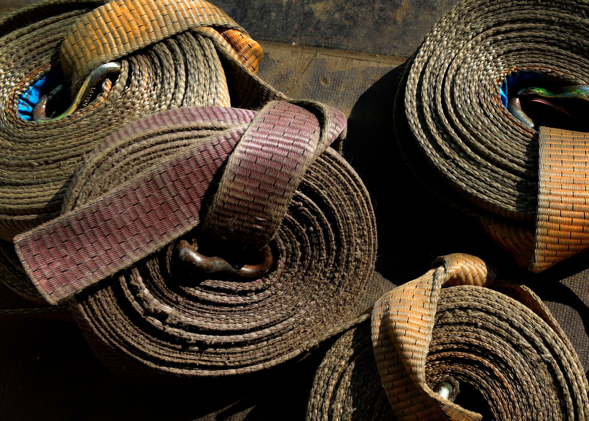 Members with the 31st Logistics Readiness Squadron traffic management office use straps to secure cargo for transportation May 12, 2015, at Aviano Air Base, Italy. Cargo is secured to ensure safe transportation between locations. (U.S. Air Force Senior Airman Areca T. Wilson/Released)