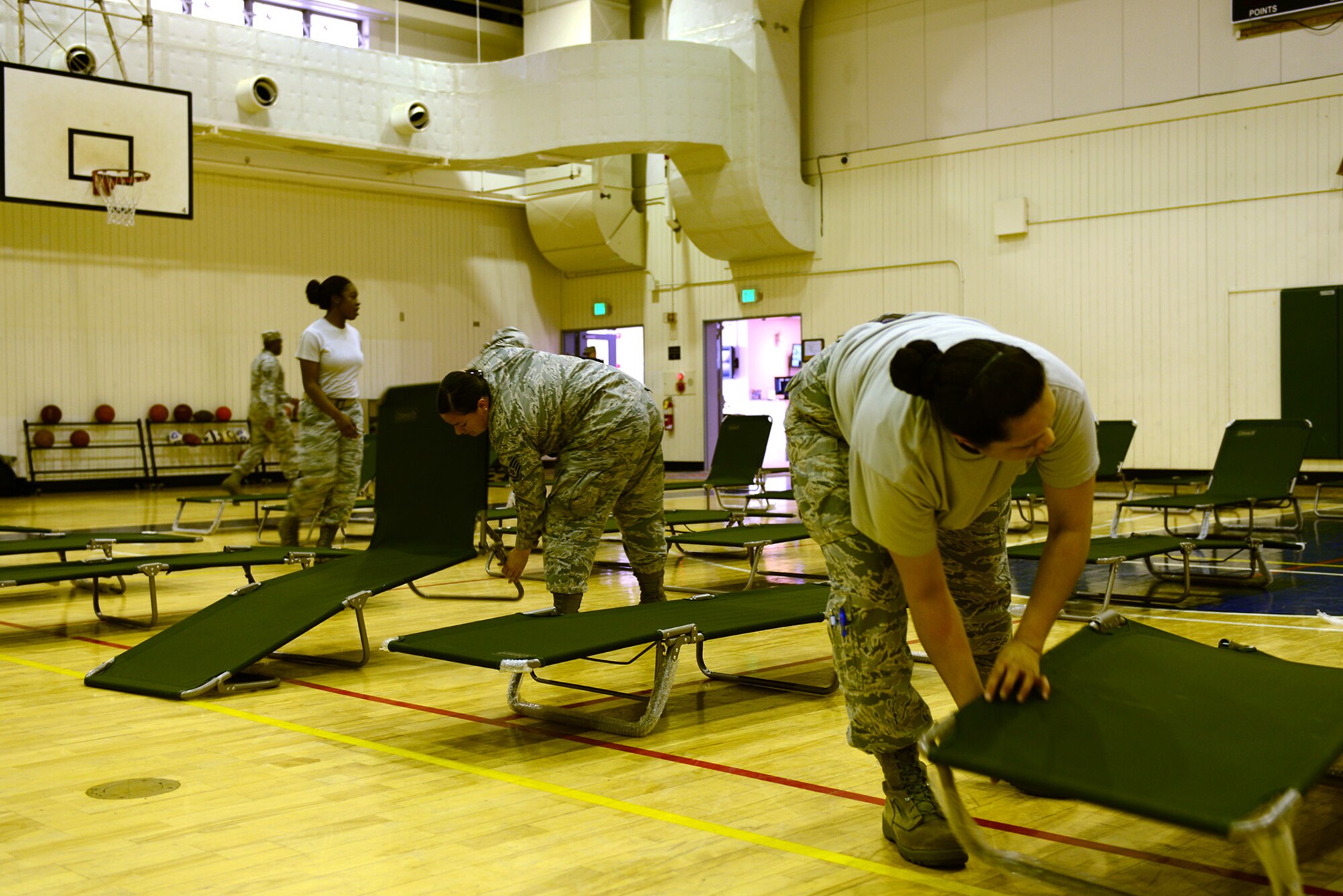 Airmen from the 374th Force Support Squadron set up the Samurai Fitness Center May 15, 2015, at Yokota Air Base, Japan. The fitness center was set up as temporary lodging for Marines whose aircraft was diverted to Yokota due to maintenance issues. (U.S. Air Force photo by Senior Airman Desiree Economides/Released)
