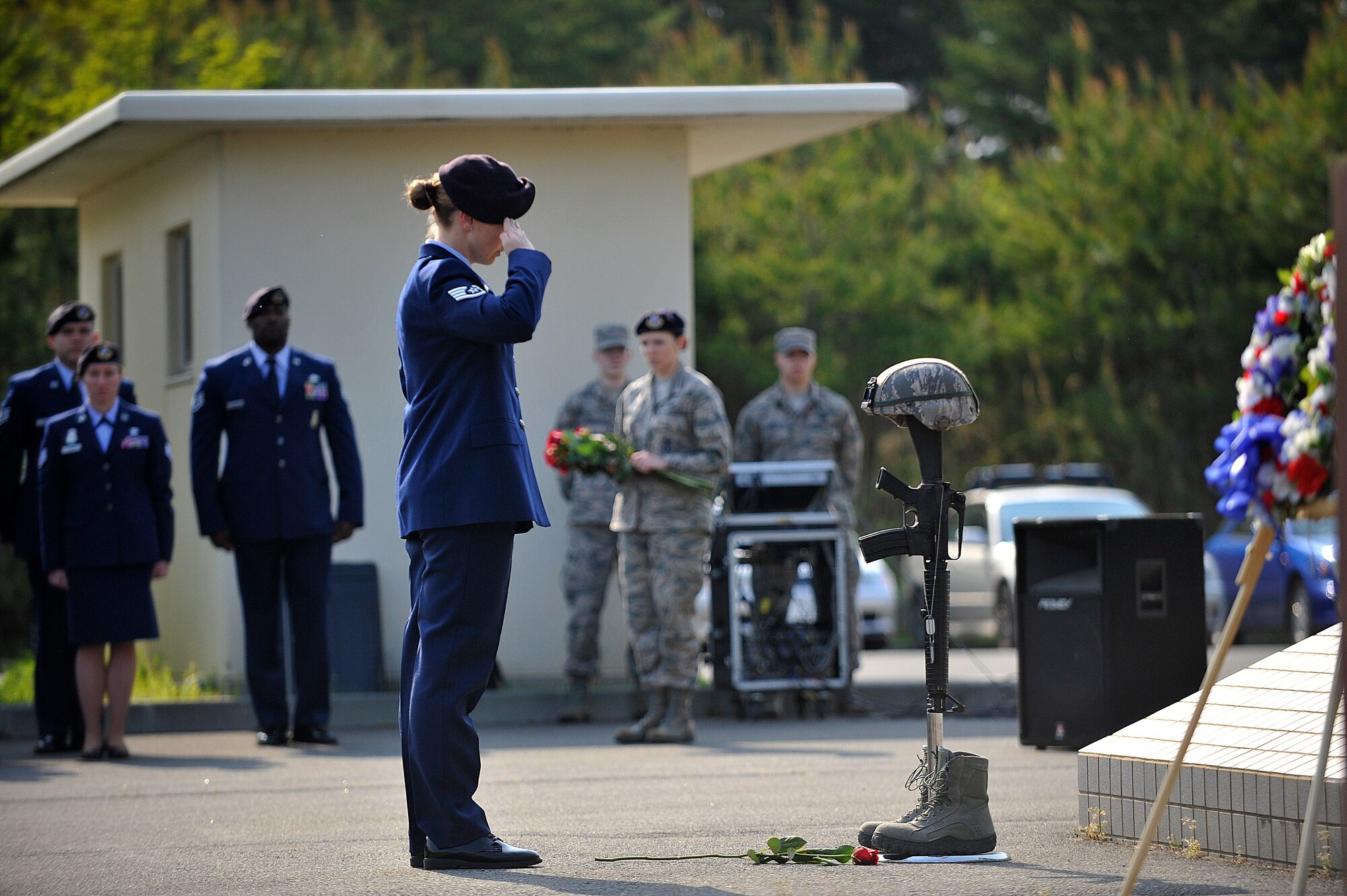 U.S. Air Force staff sergeant from the 35th Security Forces Squadron renders a salute in honor of fallen defender, Airman 1st Class Elizabeth N. Jacobson, at Misawa Air Base, Japan, May 14, 2014. Jacobson was the first female Airman killed in the line of duty in support of Operation Iraqi Freedom and the first security forces member killed in conflict since the Vietnam War. (U.S. Air Force photo by Senior Airman Jose L. Hernandez-Domitilo/Released)