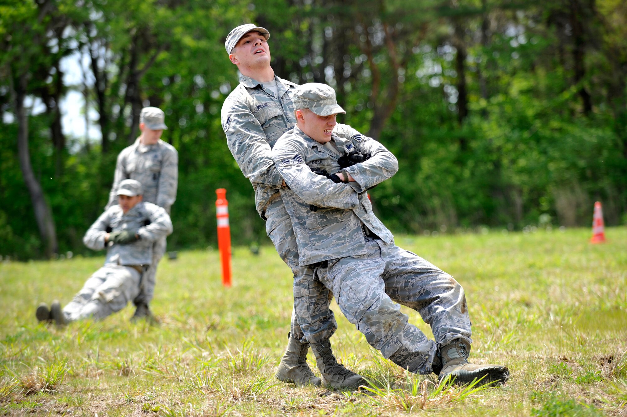 U.S. Air Force Airman 1st Class Christian Willis, 35th Security Force Squadron installation entry controller, buddy drags his team partner, Staff Sgt. Raymond Burk, 35 SFS patrolman, across a set of cones as part of a Police Week challenge at Misawa Air Base, Japan, May 14, 2015. Following a buddy drag, the Airmen had to perform a fireman carry across another array of cones. (U.S. Air Force photo by Senior Airman Jose L. Hernandez-Domitilo/Released)