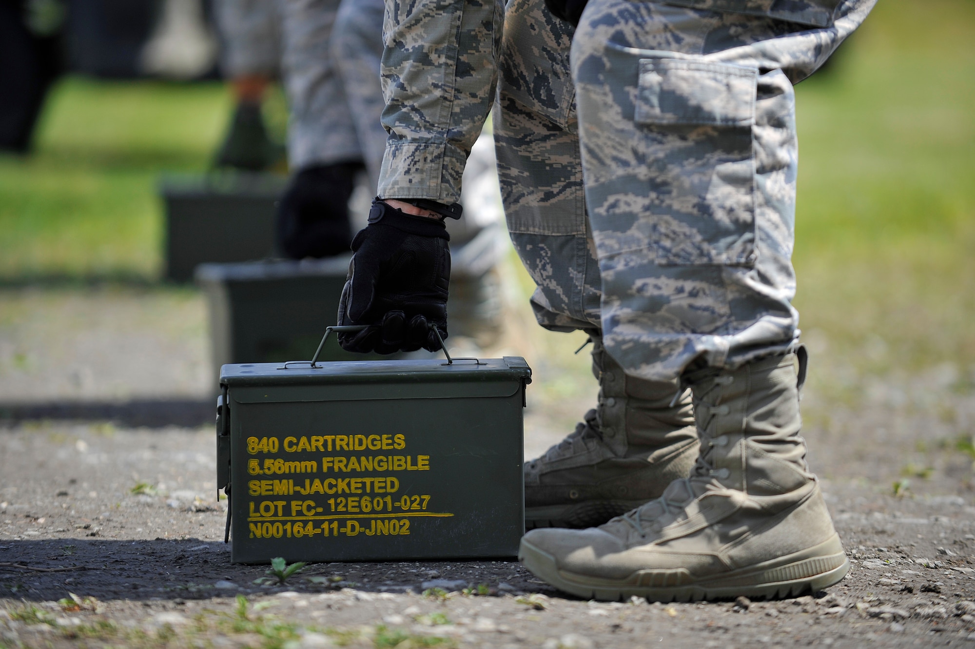A group of U.S. Air Force Airmen from the 35th Security Forces Squadron prepare to lift a box of ammunition cartridges as part of a Police Week challenge at Misawa Air Base, Japan, May 14, 2015. Each box weighed approximately 30 pounds and was used as part of a lifting challenge to test strength and endurance. (U.S. Air Force photo by Senior Airman Jose L. Hernandez-Domitilo/Released)