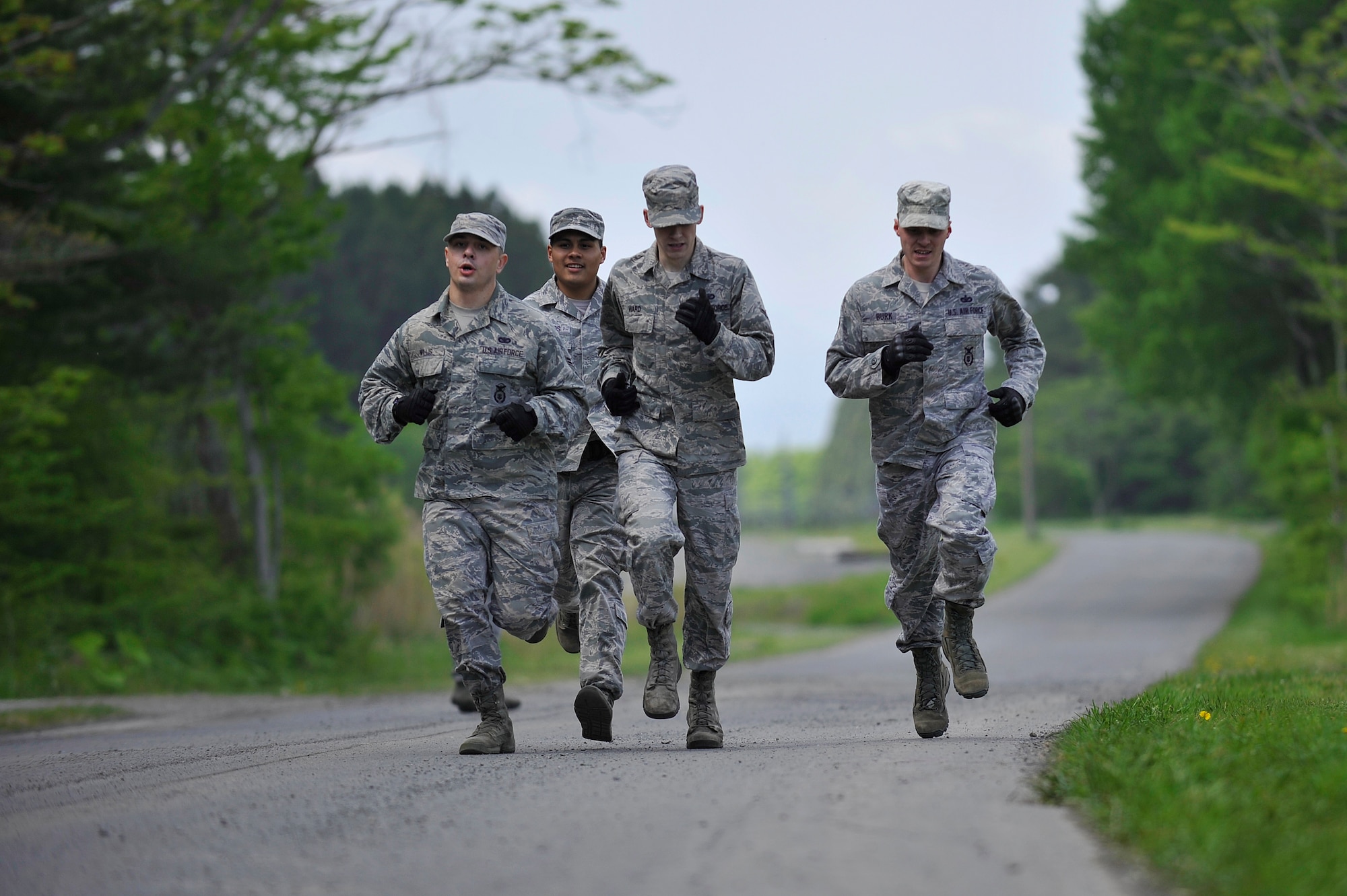 A group of U.S. Air Force Airmen from the 35th Security Forces Squadron sprint 880 meters collectively at Misawa Air Base, Japan, May 14, 2015. The run was part of a Police Week challenge course involving strength, endurance and weapons knowledge tests, hosted by the 35 SFS as part of Police Week. (U.S. Air Force photo by Senior Airman Jose L. Hernandez-Domitilo/Released) 