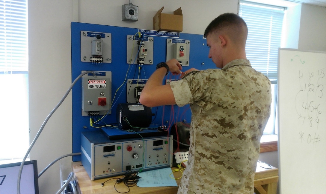 A Marine from BRACT 3-15 conducts practical application on motors.
