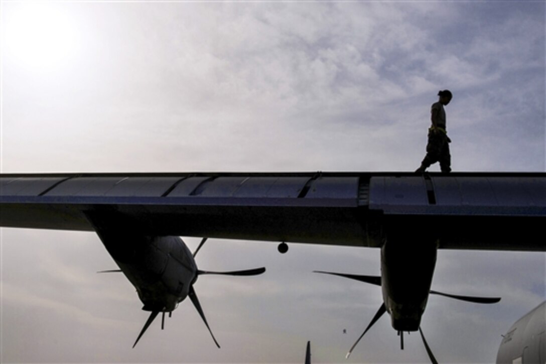 U.S. Air Force Senior Airman Mina Phouangphidok checks the wings on a C-130J Super Hercules aircraft during a post-flight inspection on the flightline at Bagram Airfield, Afghanistan, May 5, 2015. Phouangphidok is assigned to the 455th Expeditionary Aircraft Maintenance Squadron.