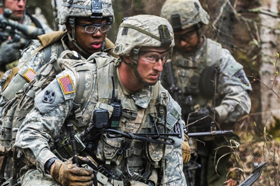 Army Staff Sgt. Heath Beesley, center, waits for the command to attack during a live-fire exercise on Joint Base Elmendorf-Richardson, Alaska, May 8, 2015. Beesley is a weapons squad leader assigned to Company C, 3rd Battalion, 509th Infantry Regiment. 
