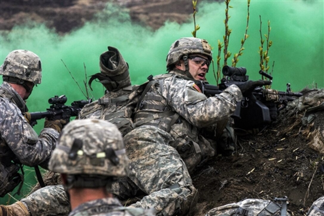 A soldier reports his status during Spartan Phoenix on Joint Base Elmendorf-Richardson, Alaska, May 8, 2015. The 25th Infantry Division’s 4th Brigade Combat Team conducted the live-fire exercise. The soldier is a machine gunner assigned to Company C, 3rd Battalion, 509th Infantry Regiment. 