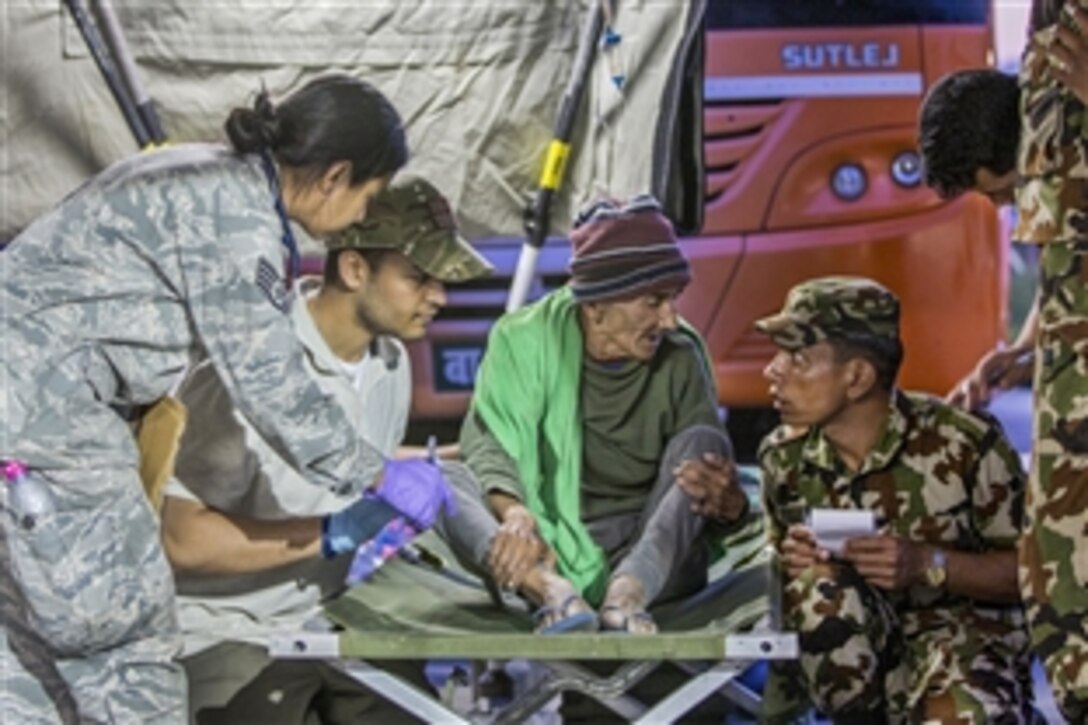 U.S. service members and Nepalese army medical personnel treat victims of a 7.3-magnitude earthquake at a medical triage area at Tribhuvan International Airport in Kathmandu, Nepal, May 12, 2015. At Nepal's request, the U.S. government created and activated Joint Task Force 505 to provide unique assistance capabilities, alongside other multinational forces and humanitarian relief organizations. 