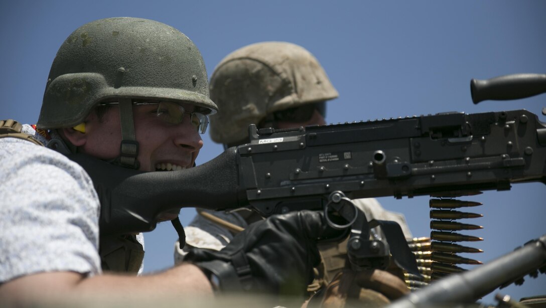 Ty R. Littau, a staff member for Senator John Thune, fires an M240B machine gun during Marine Day on Marine Corps Base Quantico, May 15, 2015. Marine Day is a day dedicated to teaching congressional staffers about Marine Corps history and ethos, as well as informing them about current and future warfighting capabilities. Over the course of the day, the staff members had the opportunity to visit the museum, fire live rounds from weapons, view a static display, and ride on Marine Corps aircraft. (U.S. Marine Corps photo by Cpl. Lena Wakayama/Released)