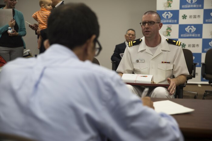 Local Japanese press interview Navy Lt. Nathan Hemerly, a family medicine doctor at the Robert M. Casey Medical and Dental Clinic, during Hemerly’s certificate of appreciation ceremony at the City Hall in Iwakuni City, Japan, May 12, 2015. After participating in the 9th annual Kintaikyo Road Race in Iwakuni City, Hemerly performed CPR, with the help of a local Japanese nurse, on another run participant who fell and became unconscious during the race. “I was just doing what I thought was the right thing to do, I wasn’t looking for any attention,” said Hemerly.