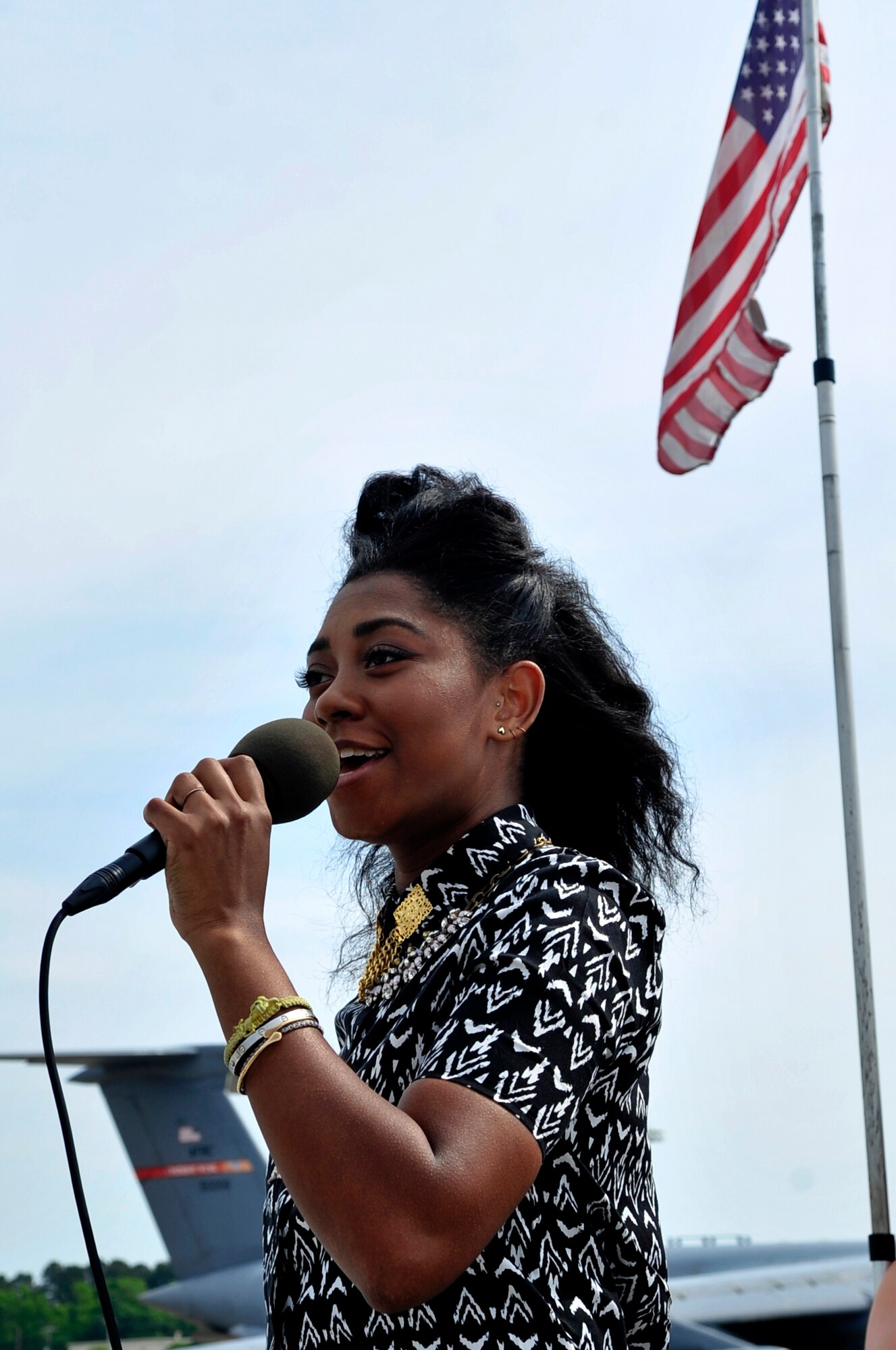 Majesty Rose, former American Idol contestant and local celebrity, sings the National Anthem during the 2015 Wings Over Wayne Airshow and Open House, May 16, 2015, at Seymour Johnson Air Force Base, North Carolina. Majesty and Kellie Pickler, country music artist, were the airshow’s featured entertainment acts. (U.S. Air Force photo/Airman Shawna L. Keyes)