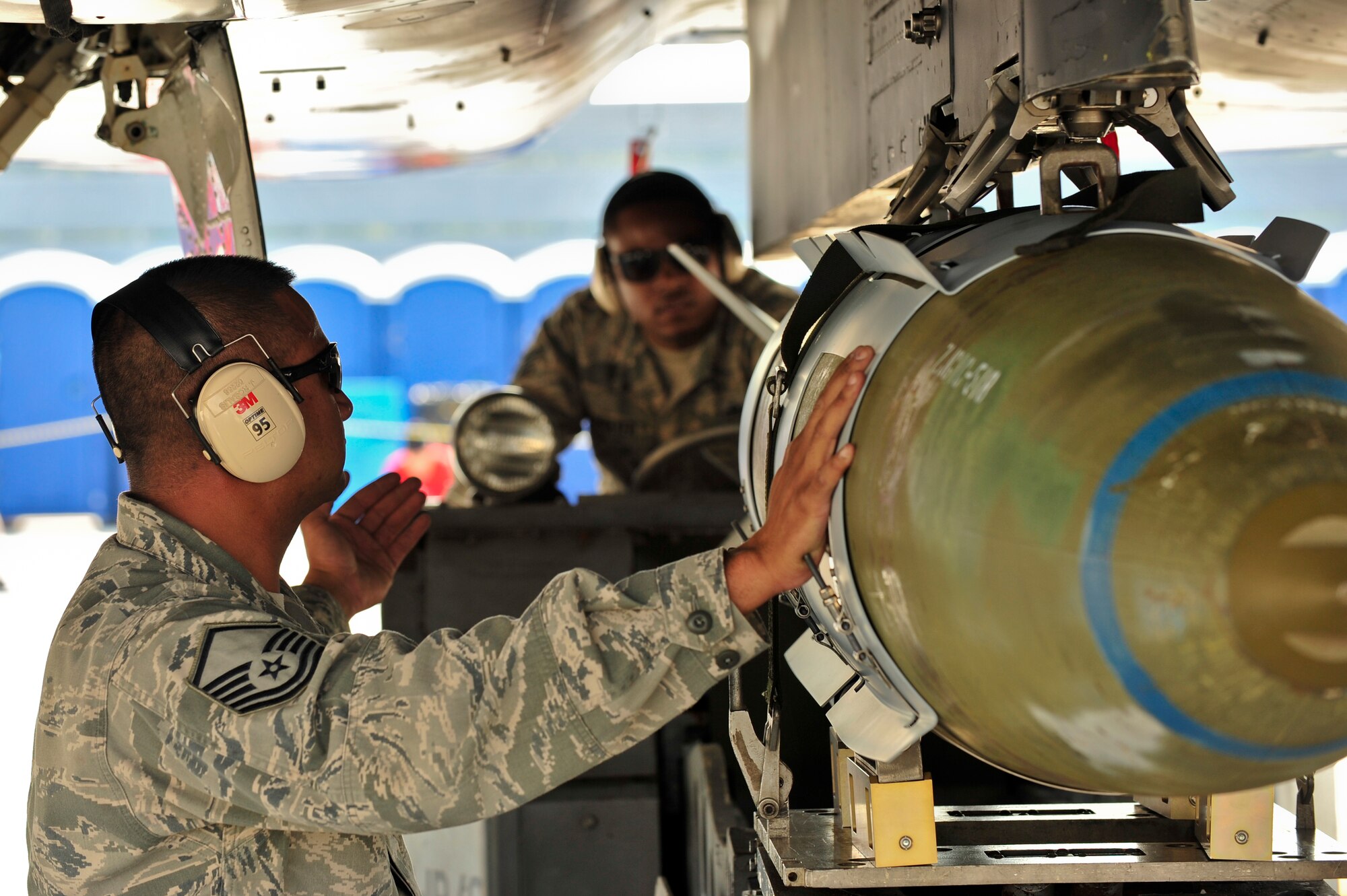 Master Sgt. Jason Rosalis (left) and Tech. Sgt. Brandon McBrayer, 4th Maintenance Group standardization load crew members, secure an inert munition as part of a demonstration during the 2015 Wings Over Wayne Airshow and Open House, May 16, 2015, at Seymour Johnson Air Force Base, North Carolina. The first day of WOW 2015 featured ground demonstrations like the load crew competition, along with aerial acts including the U.S. Air Force Thunderbirds and the “Tora, Tora, Tora!” Pearl Harbor reenactment. (U.S. Air Force photo/Airman Shawna L. Keyes)    