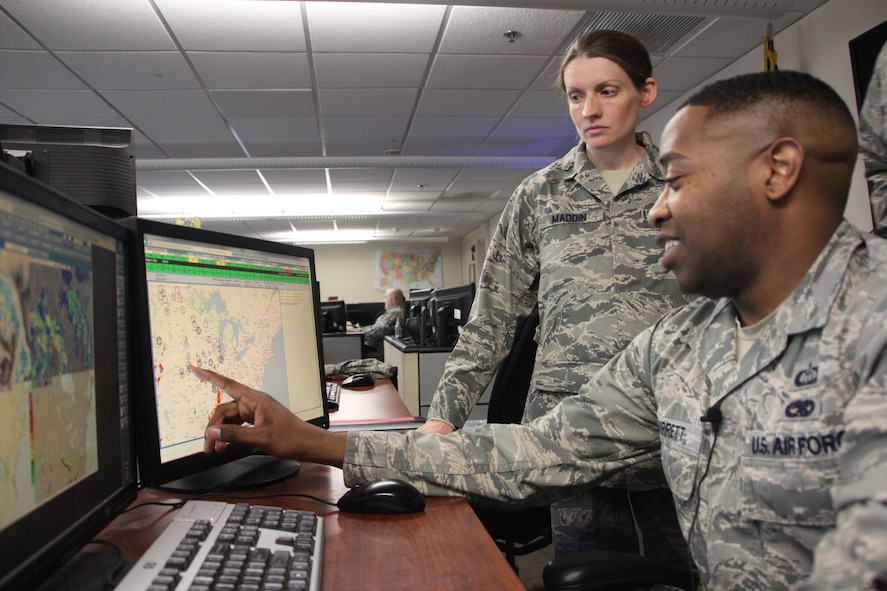 Storm season is now here in the Midwest and 932nd Airlift Wing reservists are involved in keeping track of fast moving storms.  The 12th Operational Weather Flight provides force continuity to the 15th Operational Weather Squadron at Scott Air Force Base.  Maj. Laura Maddin commander of the 12th OWF (standing) and Tech. Sgt. Nathaniel Garrett (at the monitor) look at a nationwide storm radar to see what might affect the 932nd Airlift Wing and the base.  (U.S. Air Force/Maj. Stan Paregien)