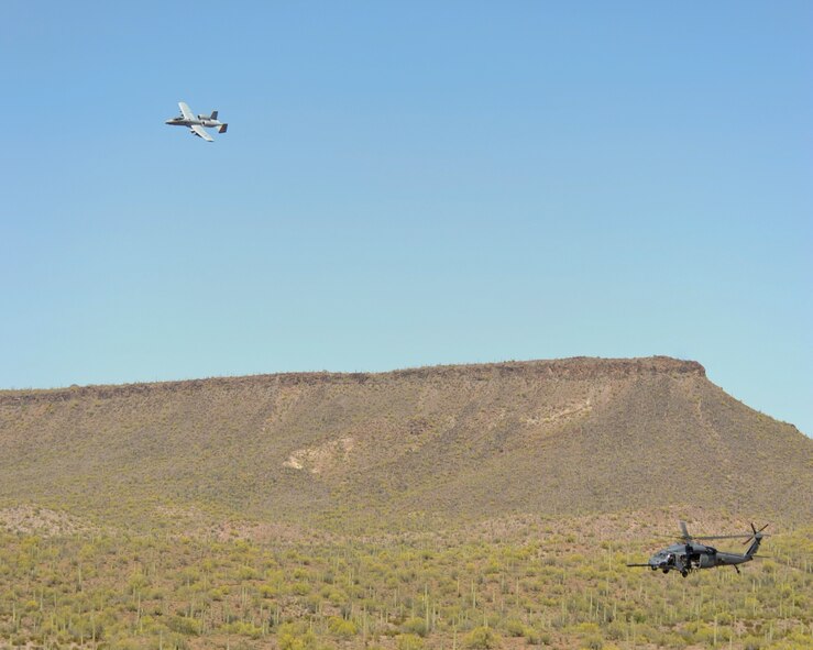 An A-10C Thunderbolt II, 357th Fighter Squadron, flies overhead providing rescue escort for a HH-60G Pave Hawk, Air Force Reserve 305th Rescue Squadron, during training at the Barry M. Goldwater Range, Ariz., April 22, 2015. The training allowed both units to achieve and maintain the capability to perform combat search and rescue missions together.  (U.S. Air Force photo by Airman 1st Class Chris Massey/Released)