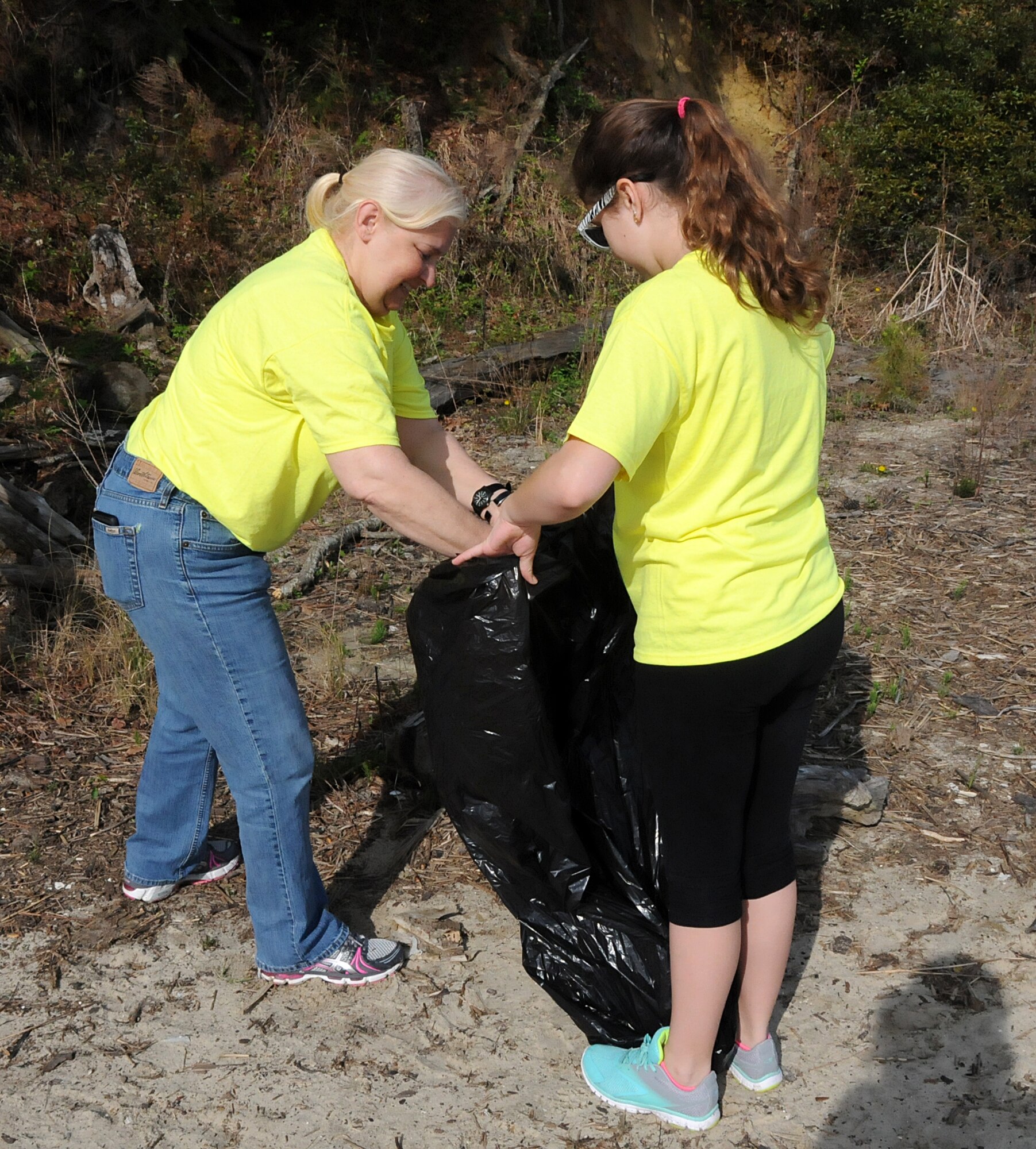 Virginia military members from the 192nd Fighter Wing, 203rd Red Horse Squadron, and the Virginia Army National Guard, and their families volunteered April 18, 2015, to help clean and improve York River State Park in Williamsburg. The families served in honor of the Month of the Military Child as they cleared waste and spread fresh mulch on the playground and around selected trees. (U.S. Air National Guard photo by Airman 1st Class Johnisa B. Roberts/Released)

