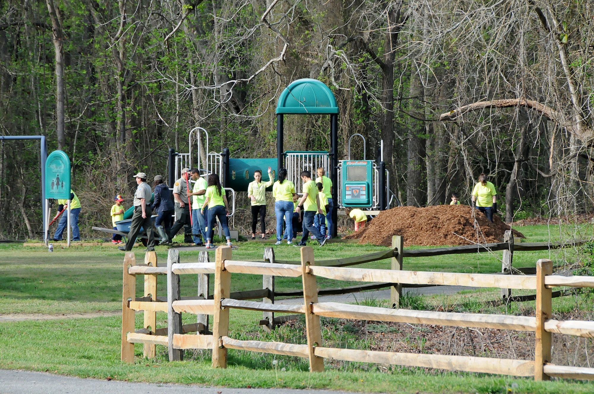 Virginia military members from the 192nd Fighter Wing, 203rd Red Horse Squadron, and the Virginia Army National Guard, and their families volunteered April 18, 2015, to help clean and improve York River State Park in Williamsburg. The families served in honor of the Month of the Military Child as they cleared waste and spread fresh mulch on the playground and around selected trees. (U.S. Air National Guard photo by Airman 1st Class Johnisa B. Roberts/Released)
