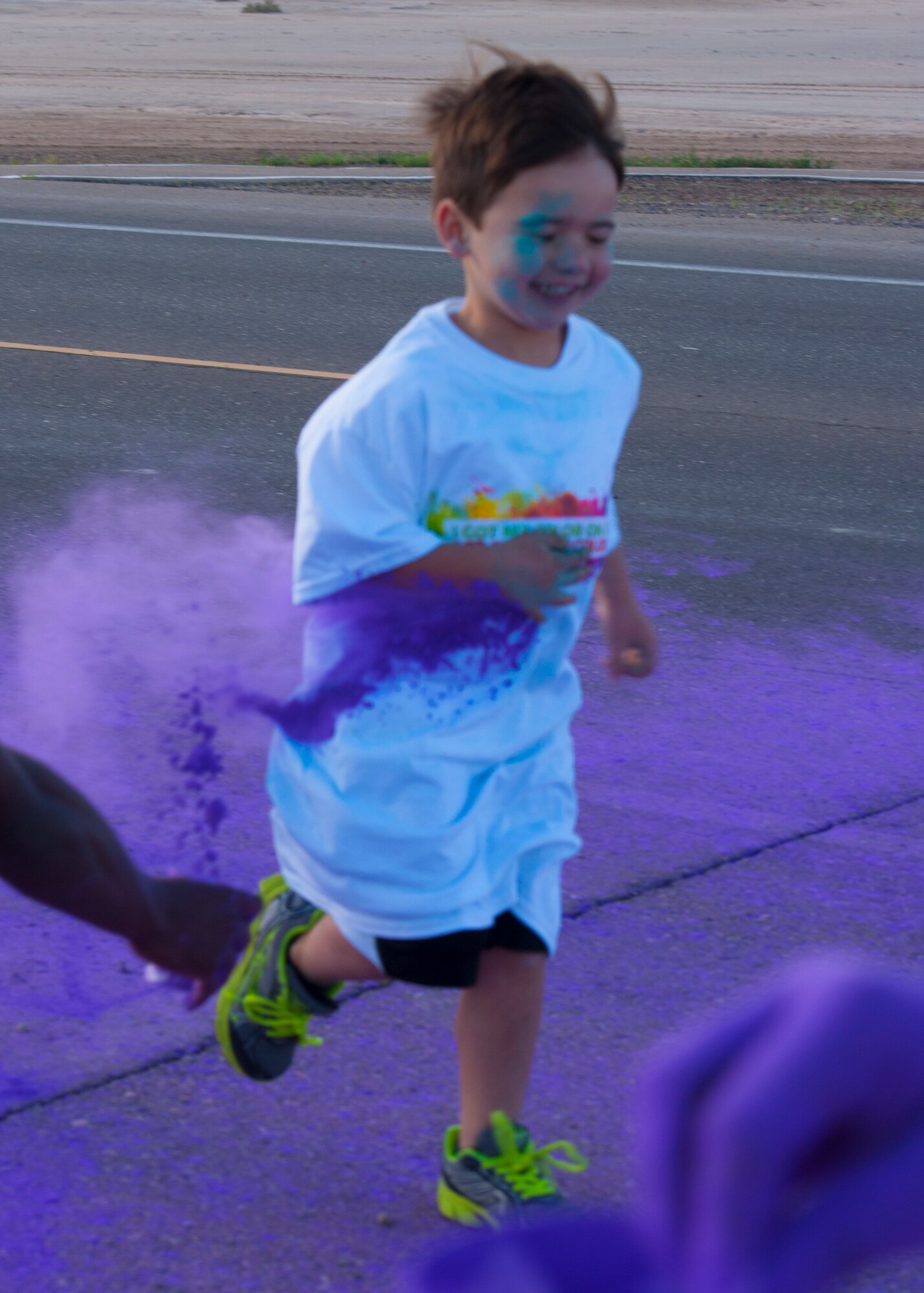 A member of Team Holloman’s dependent participates in participates in the Art Blast Color 5K Run at Holloman Air Force Base, N.M. May 16, 2015. The Domenici Fitness Center hosts monthly fun runs to help boost morale and get members of Team Holloman enthused about getting and staying fit. (U.S. Air Force photo by Staff Sgt. E’Lysia A. Wray/Released)