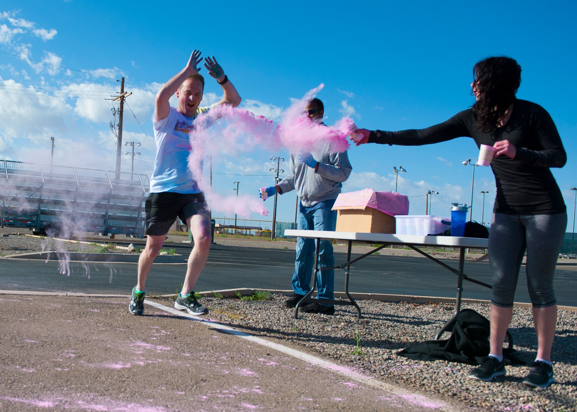 Colonel Robert Kiebler, 49th Wing commander, participates in the Art Blast Color 5K Run at Holloman Air Force Base, N.M. May 16, 2015. The Domenici Fitness Center hosts monthly fun runs to help boost morale and get members of Team Holloman enthused about getting and staying fit. (U.S. Air Force photo by Senior Airman Leah Ferrante/Released)