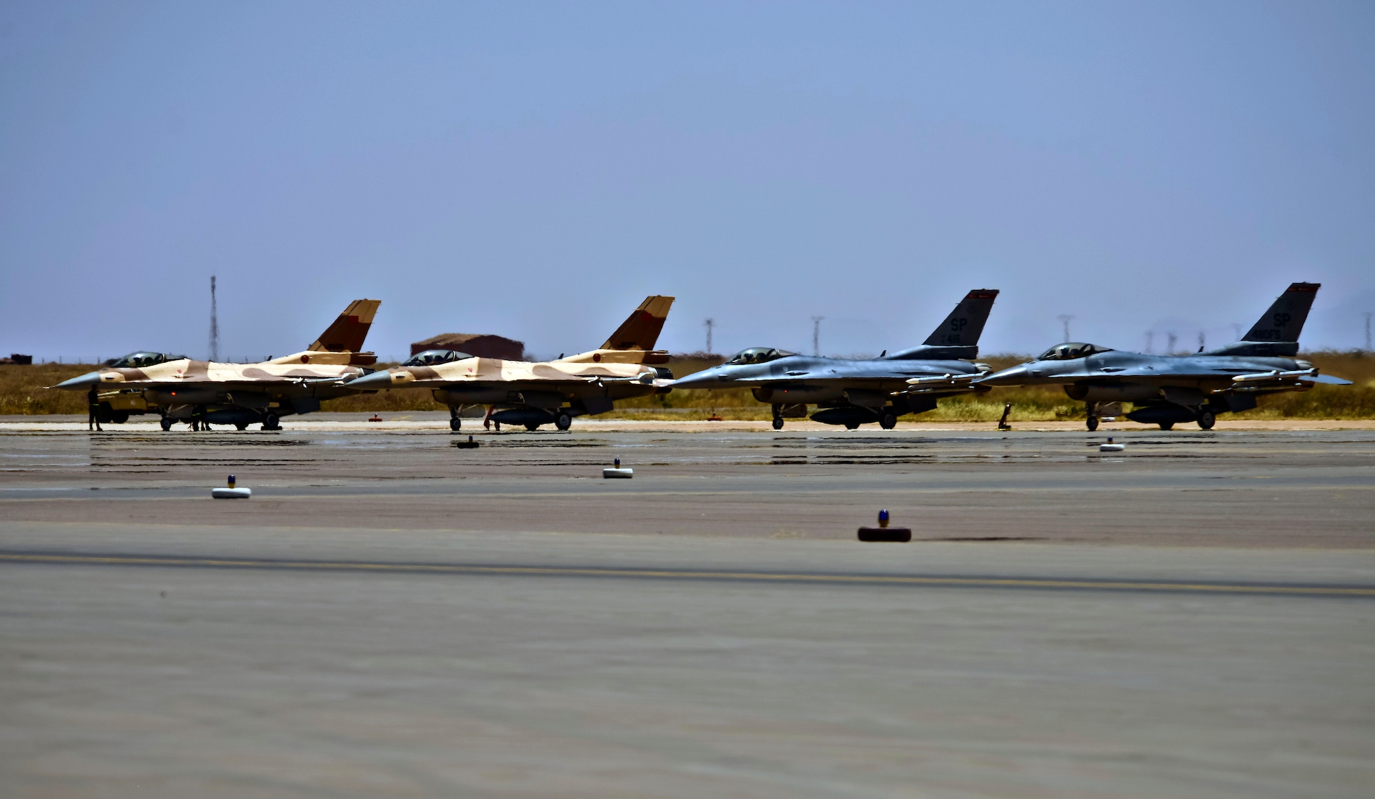 A group of F-16 Fighting Falcon aircraft assigned to the 480th Fighter Squadron and the Royal Moroccan air force prepare for take-off at Ben Guerir Air Base, Morocco, May 11, 2015. The 480th FS is taking part in Exercise African Lion, the largest Department of Defense exercise in Africa.  They will train with Royal Moroccan air force F-16 pilots as well as Air National Guard and Air Force Reserve Airmen. Exercise African Lion is a U.S. Marine Corps led event with participation from the U.S. Army, German Armed Forces, British Armed Forces, Netherlands, Belgium, Senegal and Tunisia. (U.S. Air Force photo by Staff Sgt. Eboni Reams)