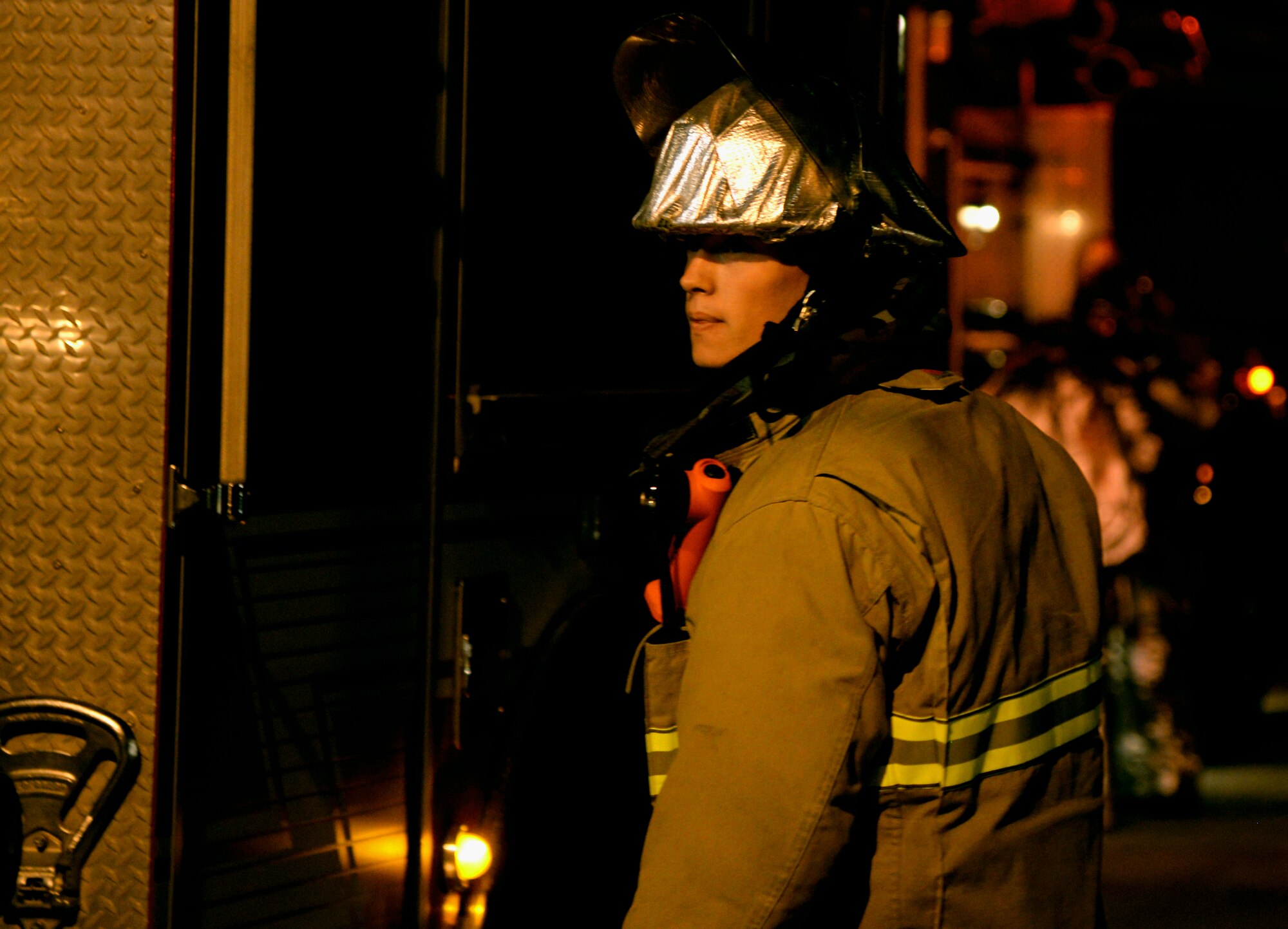 A firefighter from the 51st Civil Engineer Squadron prepares to put on his gas mask during a simulated mass casualty exercise May 12, 2015, at Osan Air Base, Republic of Korea. Members of Team Osan are participating in the combat exercise in order to focus on readiness, test Osan’s wartime procedures, and realistically look at our ability to defend the base, execute operations and receive follow-on forces. (U.S. Air Force photo by Staff Sgt. Benjamin Sutton/Released) 