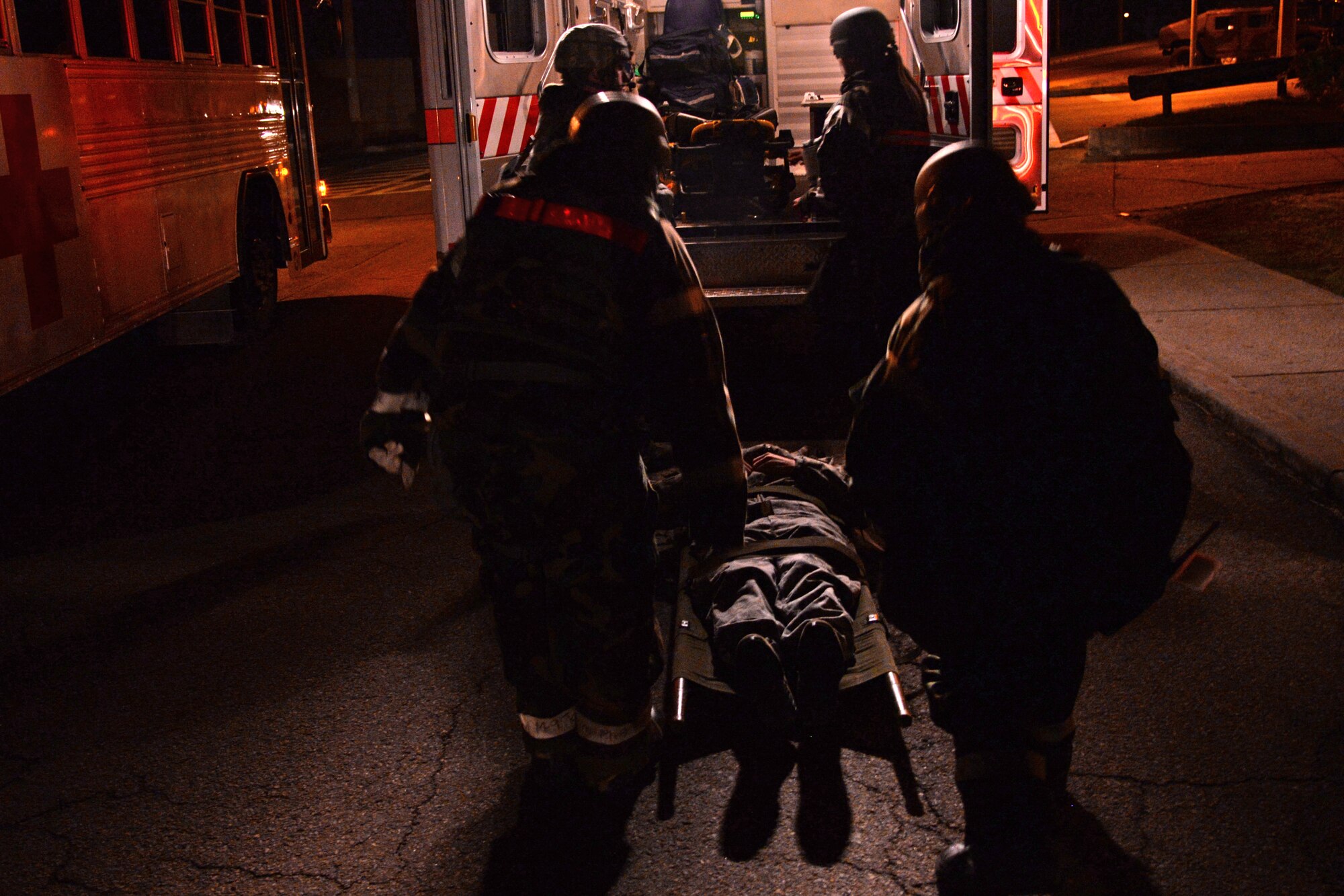 Medical first-responders from the 51st Medical Group prepare to lift a simulated victim into an ambulance during a simulated mass casualty exercise May 12, 2015, at Osan Air Base, Republic of Korea. Team Osan is participating in the combat exercise Beverly Midnight 15-02 which is designed to test American forces in the ROK on their mission readiness in the event of an emergency or wartime environment. (U.S. Air Force photo by Staff Sgt. Benjamin Sutton/Released)