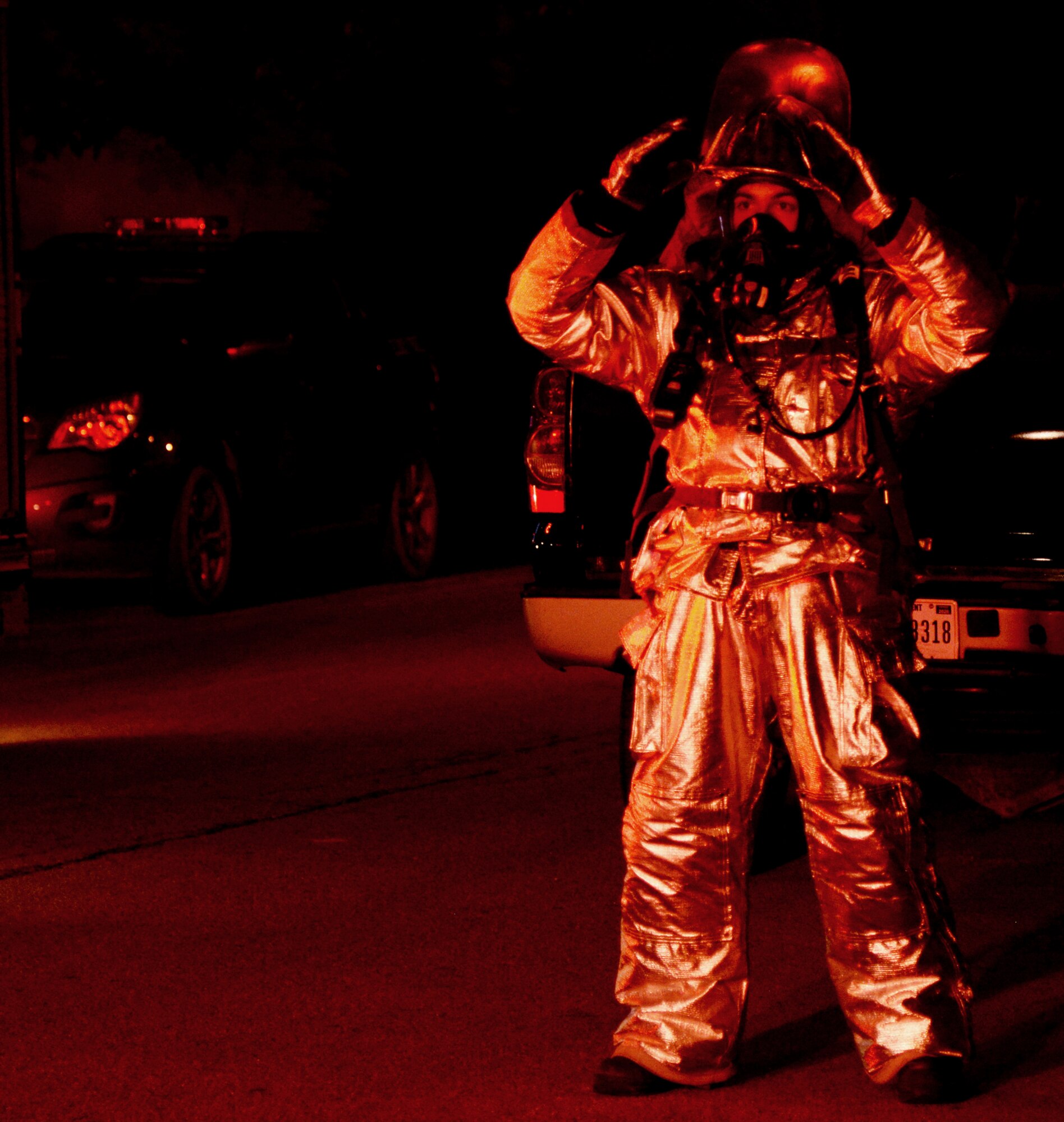 A firefighter from the 51st Civil Engineer Squadron ground guides a fire engine during a simulated mass casualty exercise May 12, 2015, at Osan Air Base, Republic of Korea. Despite wearing their standard fire-protection gear and Mission Oriented Protective Posture gear, the Airmen worked throughout the night to get simulated victims the necessary medical care during the readiness exercise Beverly Midnight 15-02. (U.S. Air Force photo by Staff Sgt. Benjamin Sutton/Released)  
