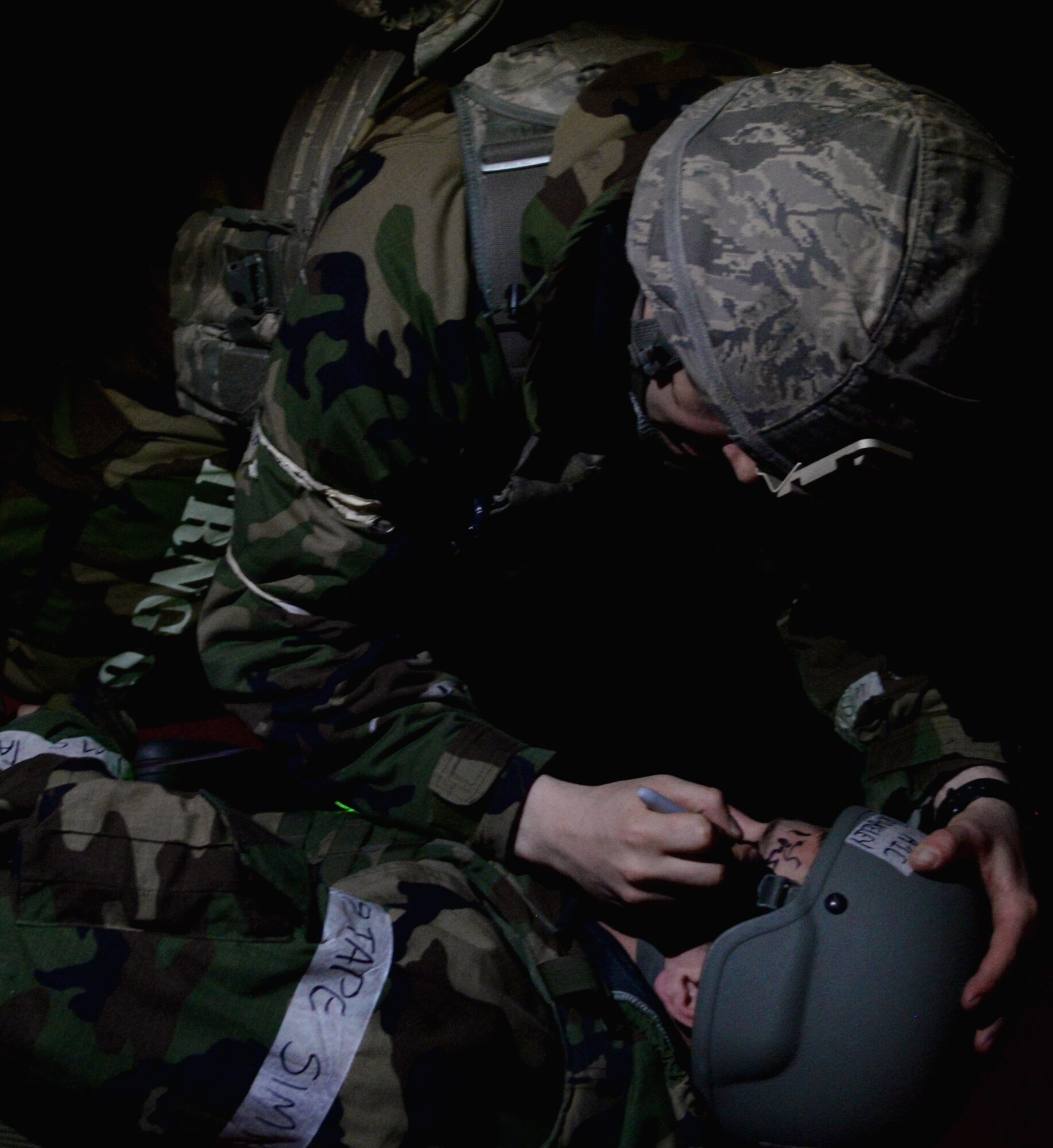 A first responder from the 51st Security Forces Squadron writes the medical status on the forehead of a mass causality exercise victim May 12, 2015, at Osan Air Base, Republic of Korea. The Airmen are participating in the combat exercise Beverly Midnight 15-02. The exercise focuses on readiness, testing Osan’s wartime procedures, and realistically looking at our ability to defend the base, execute operations and receive follow-on forces.  (U.S. Air Force photo by Staff Sgt. Benjamin Sutton/Released) 