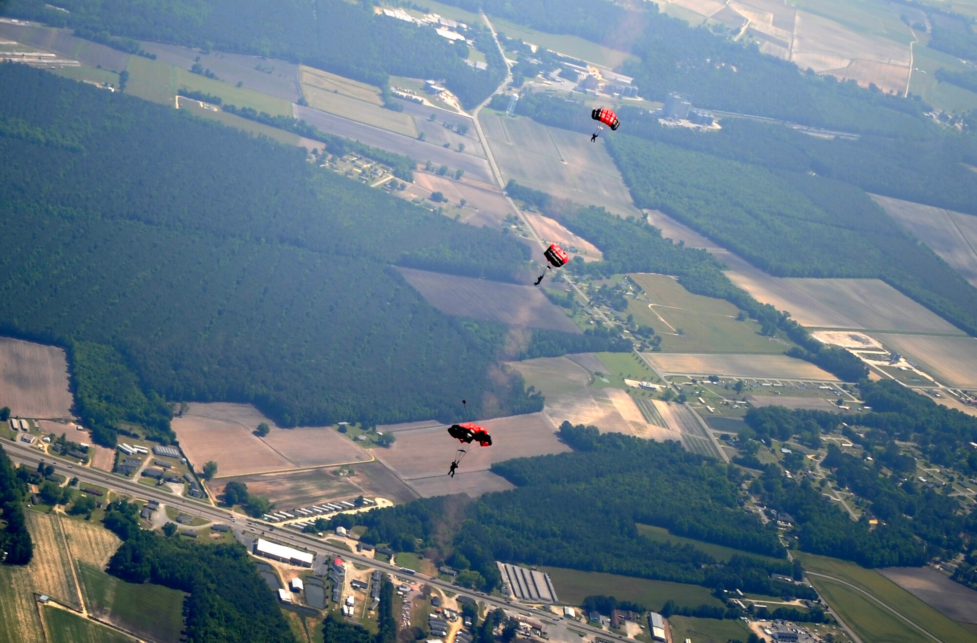 Members of the U.S. Army Black Daggers parachute demonstration team complete a high-altitude-low-opening jump during the 2015 Wings Over Wayne Airshow and open House, May 17, 2015, at Seymour Johnson Air Force Base, North Carolina. The group egressed from a C-130 Hercules during the opening ceremony of the event. (U.S. Air Force photo/Senior Airman Ashley J. Thum)