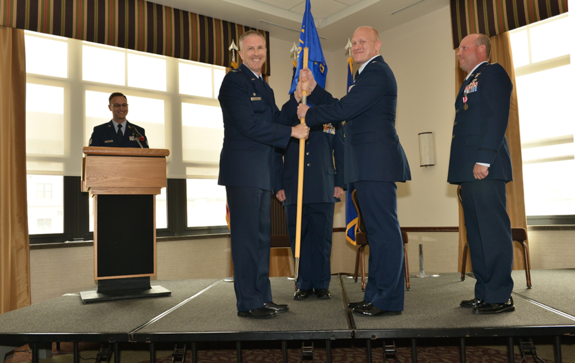 107th AW Commander Col. Robert G. Kilgore presents the 107th AW Operations Group flag to new commander, Lt. Col. Gary R. Charlton II, during a change of command ceremony at the Niagara Falls Air Reserve Station, May 16, 2015. 