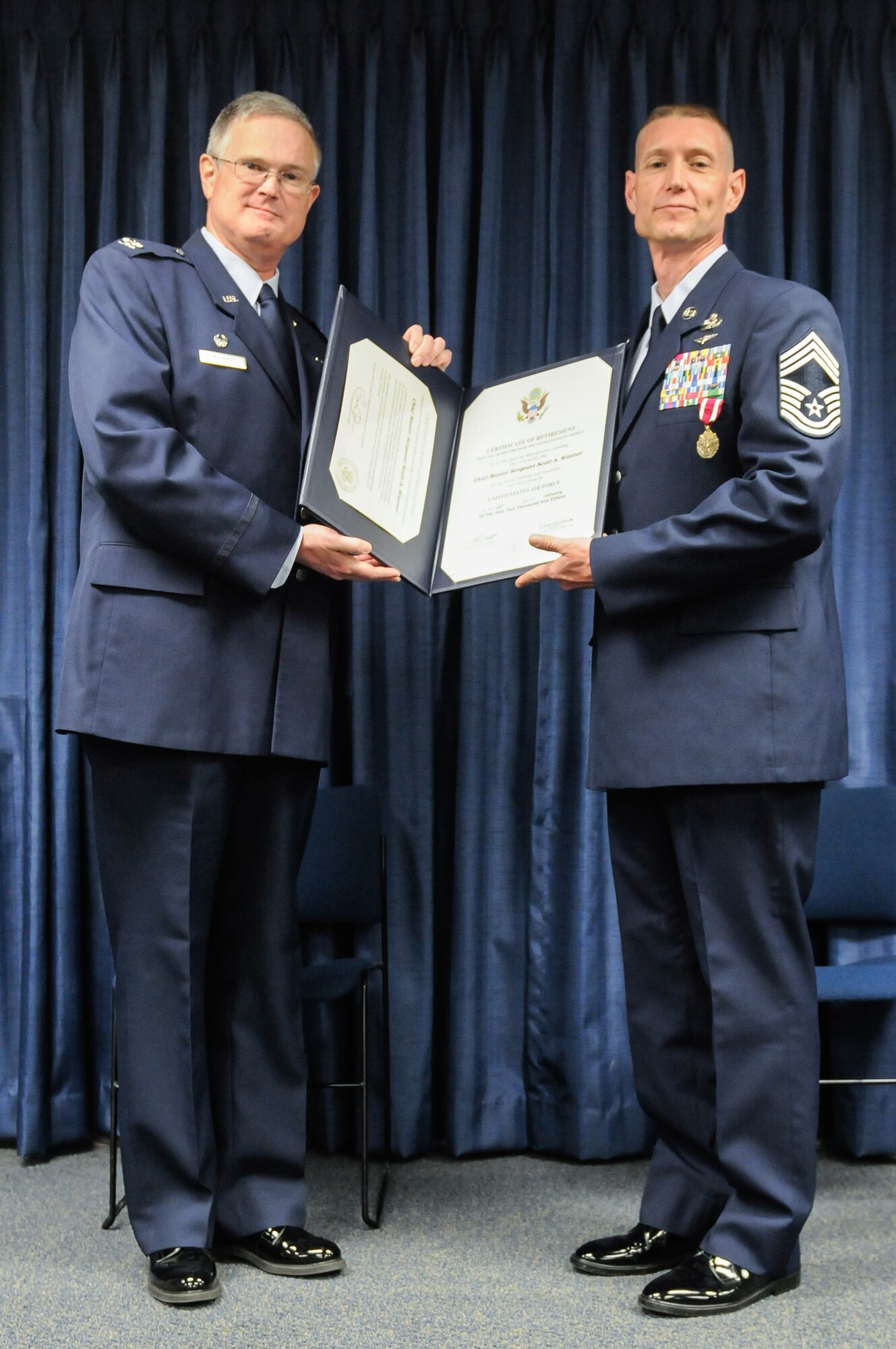 Col. David Mounkes (left), commander of the 123rd Contingency Response Group, presents Chief Master Sgt. Scott A. Wanner, the group’s chief enlisted manager, with a certificate of retirement during a ceremony held at the Kentucky Air National Guard Base in Louisville, Ky., April 26, 2015. Wanner served in the active-duty Air Force, Air Force Reserve and Air National Guard for more than 30 years. (U.S. Air National Guard photo by Staff Sgt. Vicky Spesard)
